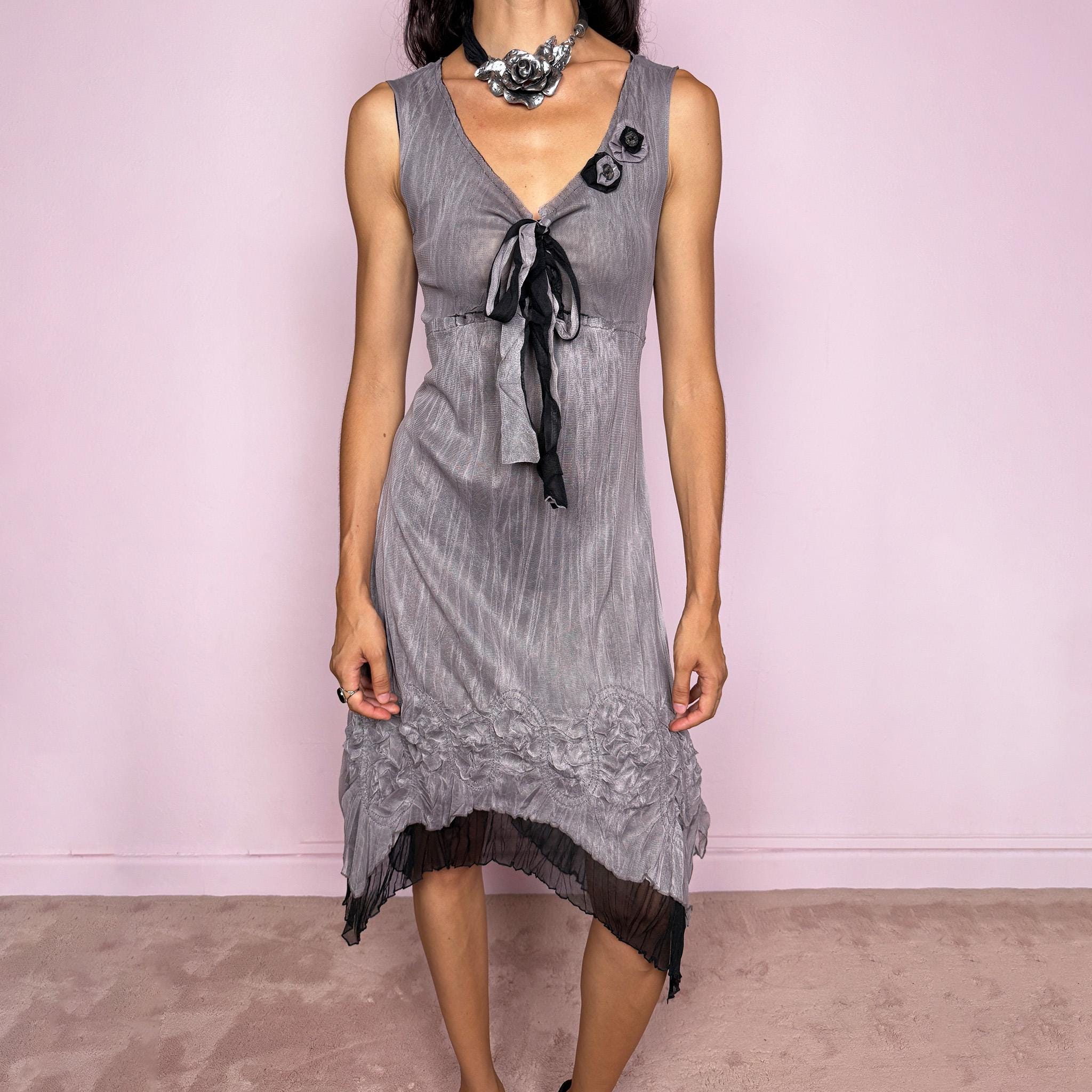 Vintage 2000s gray midi dress in stretchy sheer mesh with a black underlayer, crinkled texture, and an ethereal asymmetric silhouette. Features a deep V neckline, sleeveless cut, front tie, chest floral appliqués, and a softly flared uneven hem with dimensional pleated texture. A dark minimal avant-garde Y2K piece with an artsy feel. The composition label is missing, so the exact fabric is unknown. Excellent vintage condition.