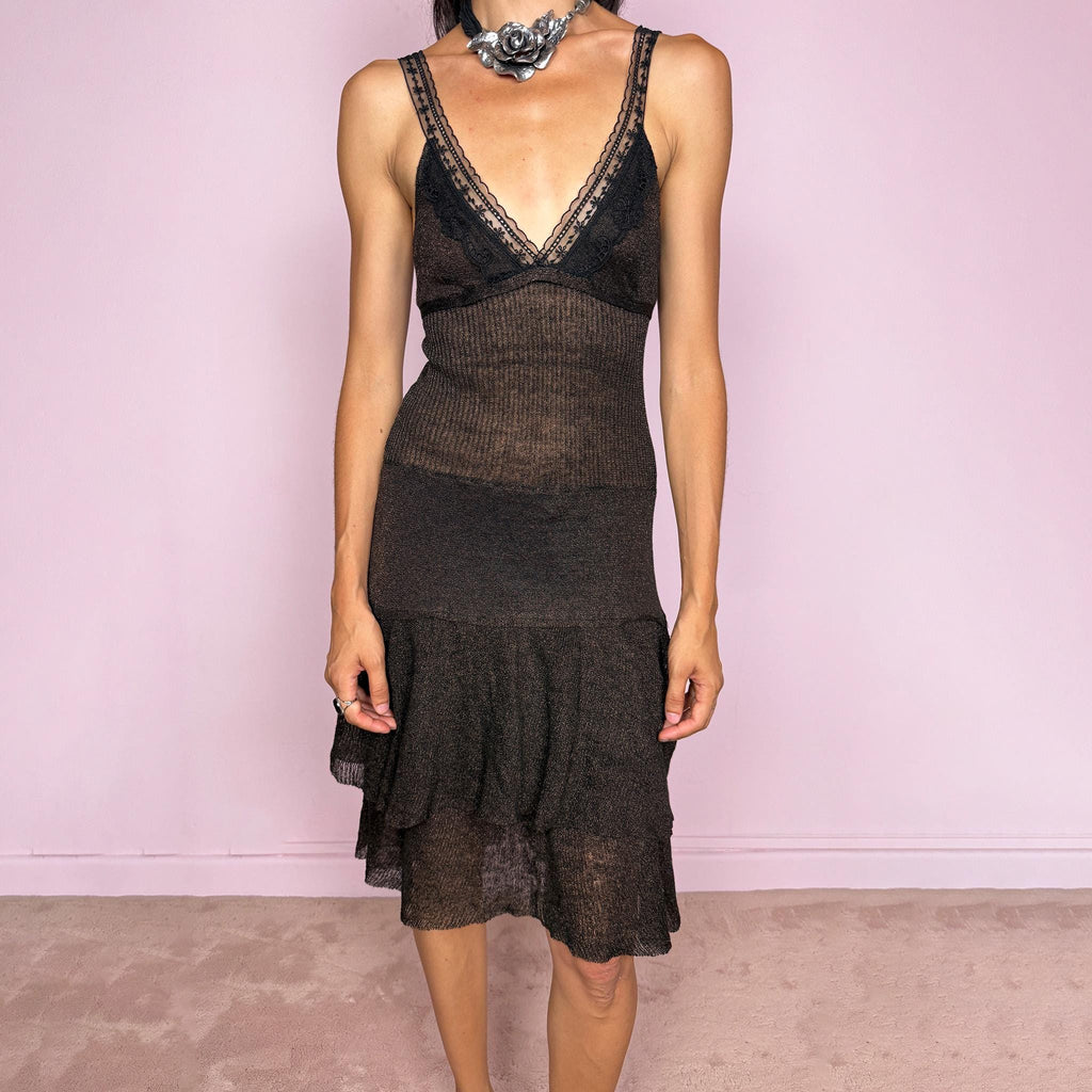 Vintage 2000s midi dress in a dark brown tone with a subtle bronze shimmer and semi-sheer textured finish. It features a delicate lingerie-inspired V neckline with black lace trim, straps, a fitted stretch body, tie-back detail, and a softly flared skirt with layered ruffle panels. A sensual Y2K piece with a moody feminine feel, ideal for an elevated gothic fairy evening look. Made in Italy by Liu Jo from a stretchy 78% linen and 22% metallic fibre blend. Excellent vintage condition.