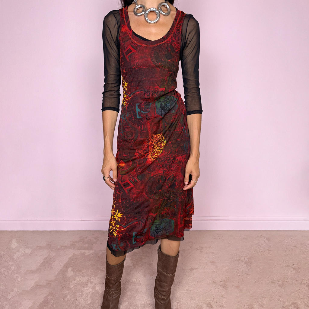 Vintage 2000s layered mesh midi dress, designed as a two-piece dress set that can be worn together or separately. The outer dress is sleeveless and stretchy, featuring a deep burgundy, red, and black graphic print with abstract ornamental motifs, while the inner layer is a sheer black mesh dress with 3/4 sleeves and a ruffled hem. A very versatile art-to-wear Y2K piece with dark maximalist layered transparency from a French brand.