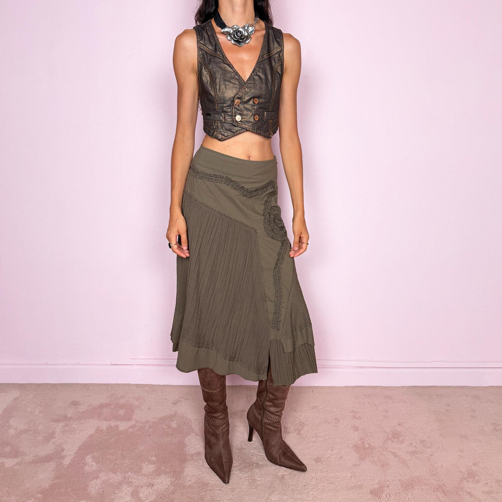 Vintage 2000s dark khaki asymmetric midi skirt designed with an irregular layered silhouette combining pleated panels, curved seam construction, sculptural ruffled appliqué detailing, a side zip closure, and a layered hem. Ideal for unique earthy fairy styling. Can be worn high-waisted for size S or lower on the waist for sizes XS–XXS. Made in France by a French brand from a non-stretch blend of 61% viscose and 39% polyamide. Great vintage condition.