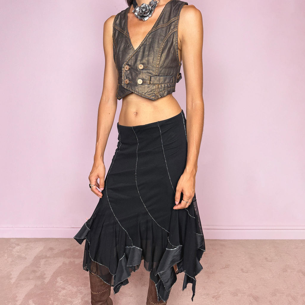Vintage 2000s black mesh midi skirt, featuring a fluid asymmetric layered construction with sheer panels and an irregular handkerchief hem. Finished with contrasting metallic thread along the curved seams and edges, creating a subtle shimmering effect throughout. Stretchy with an elasticated waist, ideal for statement evening looks. Can be worn mid- to low-rise for size S. Made in Italy from 95% viscose. Excellent vintage condition.
