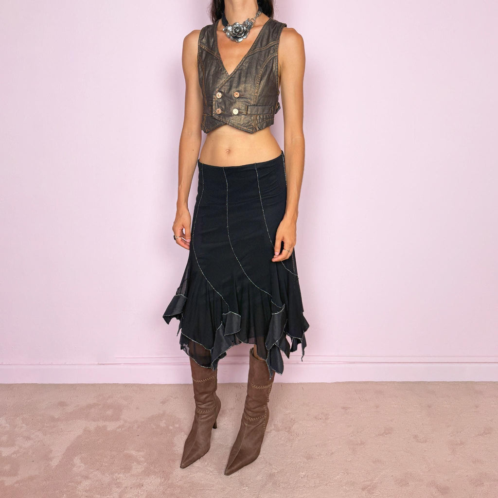 Vintage 2000s black mesh midi skirt, featuring a fluid asymmetric layered construction with sheer panels and an irregular handkerchief hem. Finished with contrasting metallic thread along the curved seams and edges, creating a subtle shimmering effect throughout. Stretchy with an elasticated waist, ideal for statement evening looks. Can be worn mid- to low-rise for size S. Made in Italy from 95% viscose. Excellent vintage condition.
