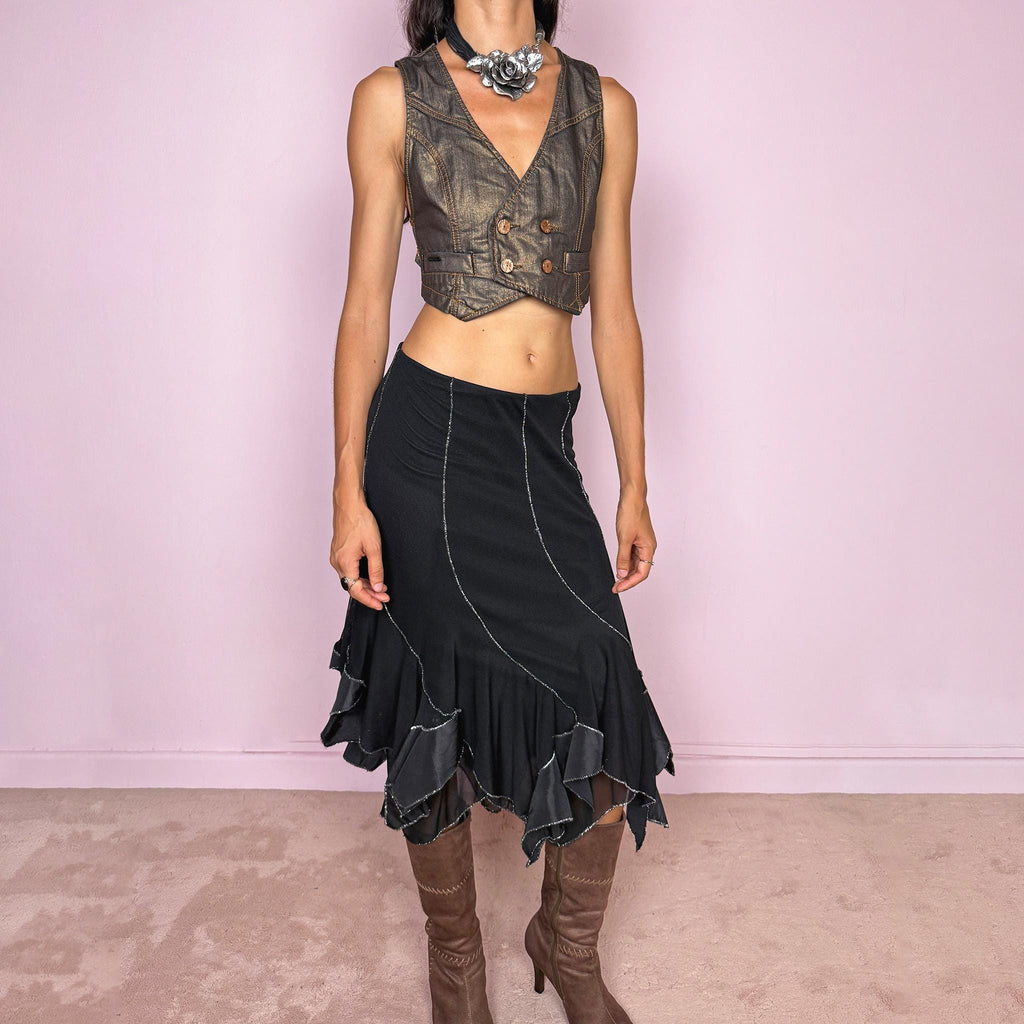 Vintage 2000s black mesh midi skirt, featuring a fluid asymmetric layered construction with sheer panels and an irregular handkerchief hem. Finished with contrasting metallic thread along the curved seams and edges, creating a subtle shimmering effect throughout. Stretchy with an elasticated waist, ideal for statement evening looks. Can be worn mid- to low-rise for size S. Made in Italy from 95% viscose. Excellent vintage condition.