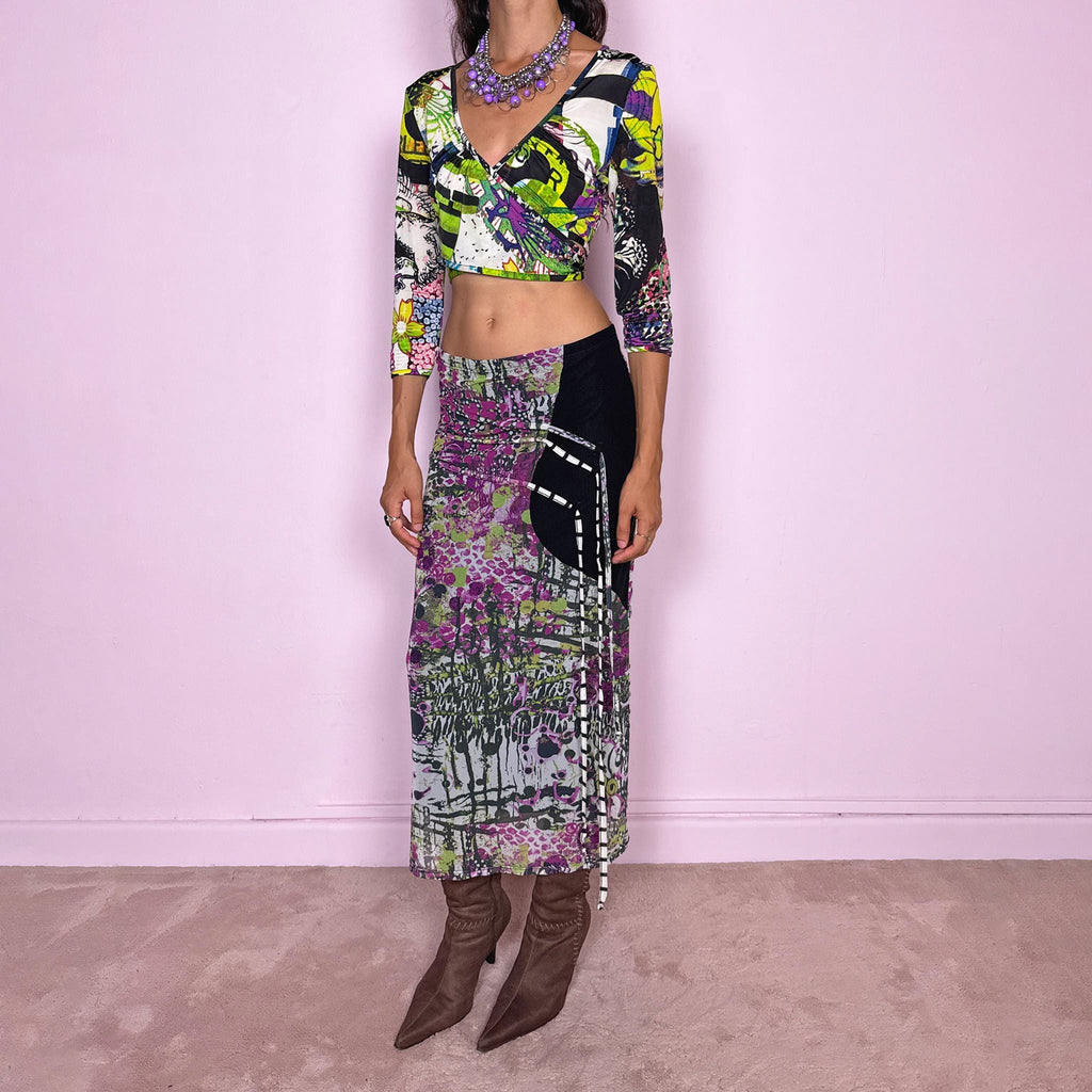 Vintage 2000s two-piece set featuring a fitted wrap-style crop top and matching printed midi skirt. The top has three-quarter sleeves, a deep V-neckline, and an adjustable tie-back closure. The matching skirt is made from stretchy mesh with an elasticated waist and abstract graphic print, featuring ruched detailing through the hip and decorative trailing straps for an asymmetric, deconstructed finish. It can be worn mid- to low-rise.