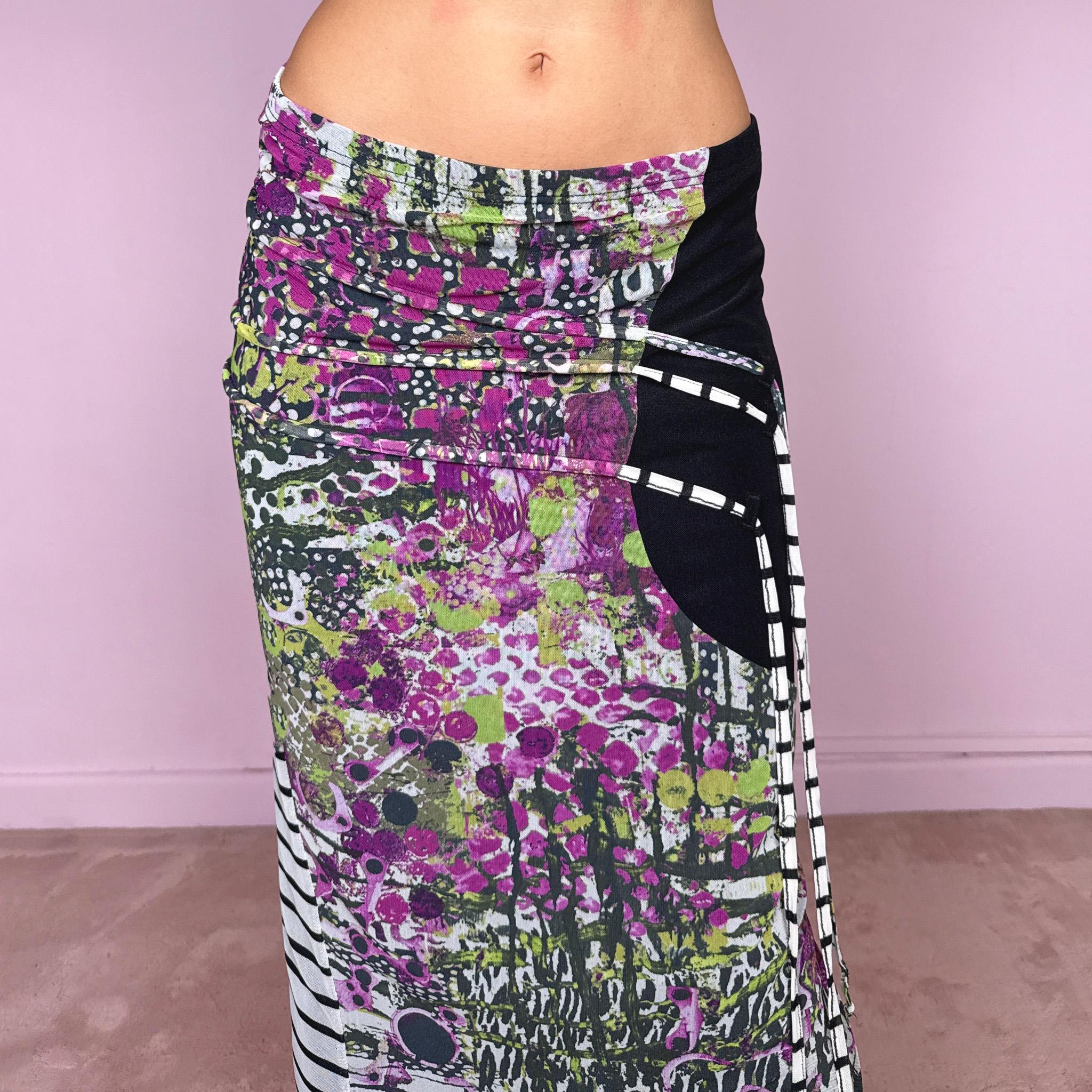 Vintage 2000s two-piece set featuring a fitted wrap-style crop top and matching printed midi skirt. The top has three-quarter sleeves, a deep V-neckline, and an adjustable tie-back closure. The matching skirt is made from stretchy mesh with an elasticated waist and abstract graphic print, featuring ruched detailing through the hip and decorative trailing straps for an asymmetric, deconstructed finish. It can be worn mid- to low-rise.