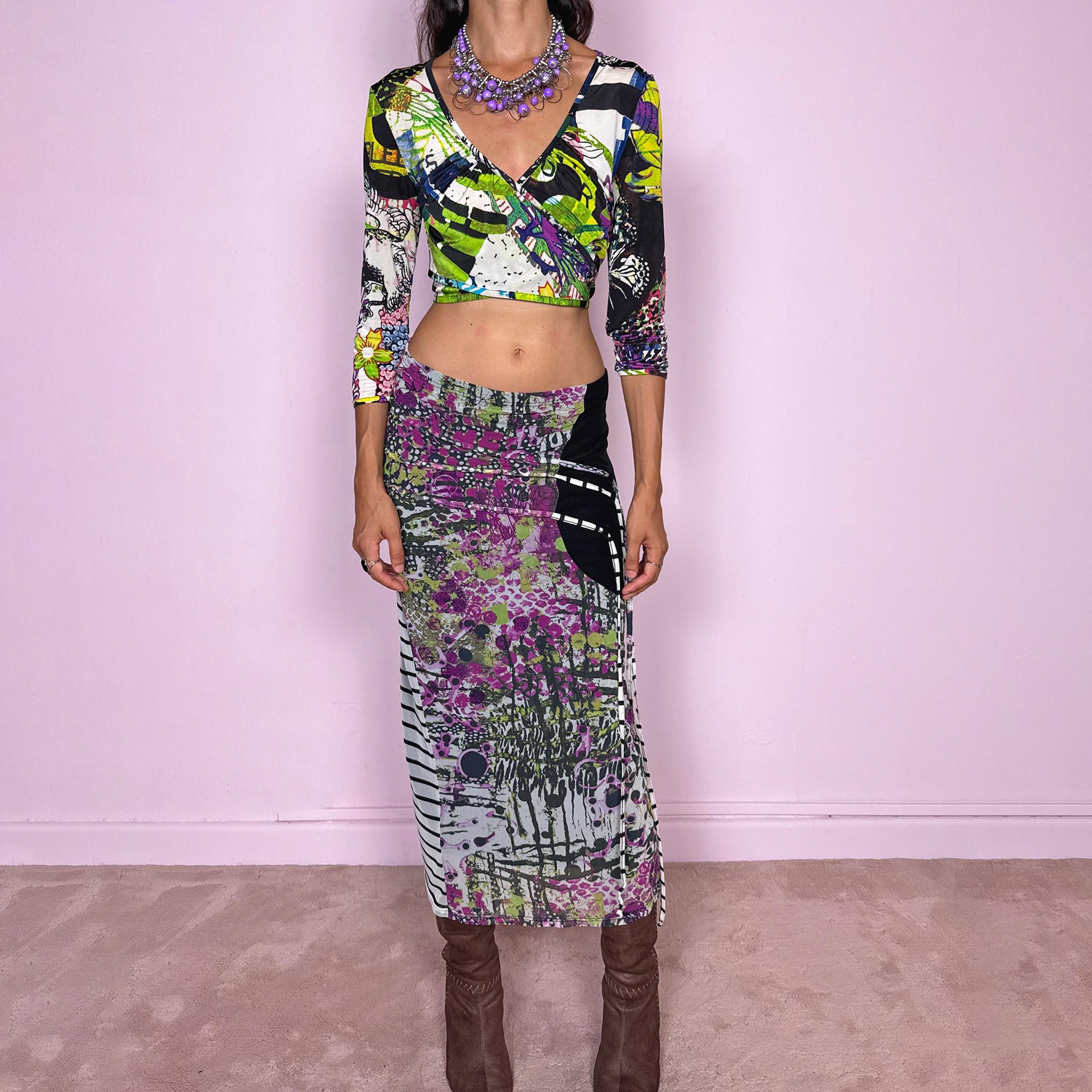 Vintage 2000s two-piece set featuring a fitted wrap-style crop top and matching printed midi skirt. The top has three-quarter sleeves, a deep V-neckline, and an adjustable tie-back closure. The matching skirt is made from stretchy mesh with an elasticated waist and abstract graphic print, featuring ruched detailing through the hip and decorative trailing straps for an asymmetric, deconstructed finish. It can be worn mid- to low-rise.