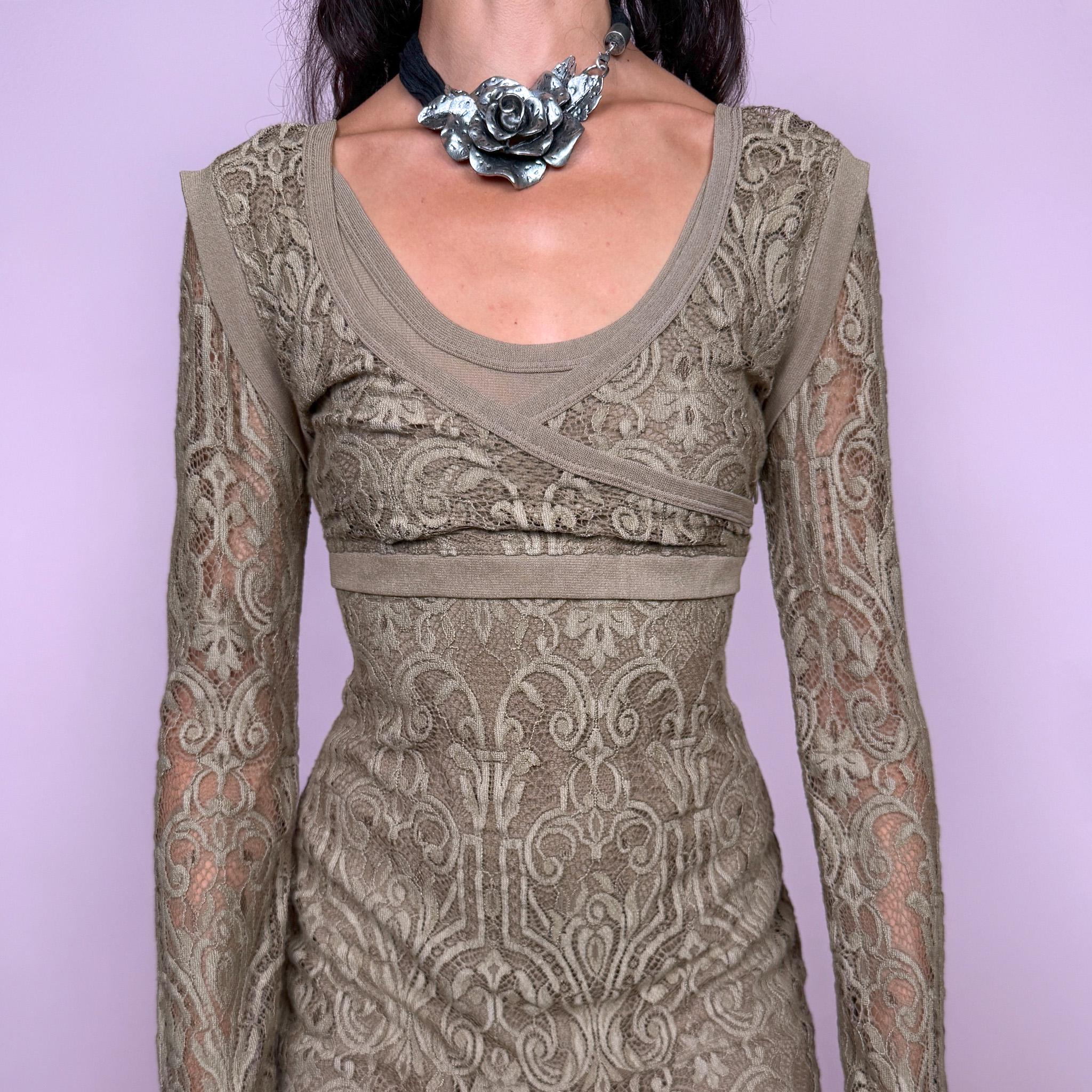 Vintage 2000s Save the Queen midi dress in an antique golden beige-brown tone, crafted from intricate stretch lace with an ornate baroque-inspired pattern throughout. Features long semi-sheer lace sleeves, a wide scoop neckline, layered asymmetric panel detailing across the bust, and a side zip closure. An elegant Y2K Italian design. Made in Italy from 100% polyamide. Excellent vintage condition.