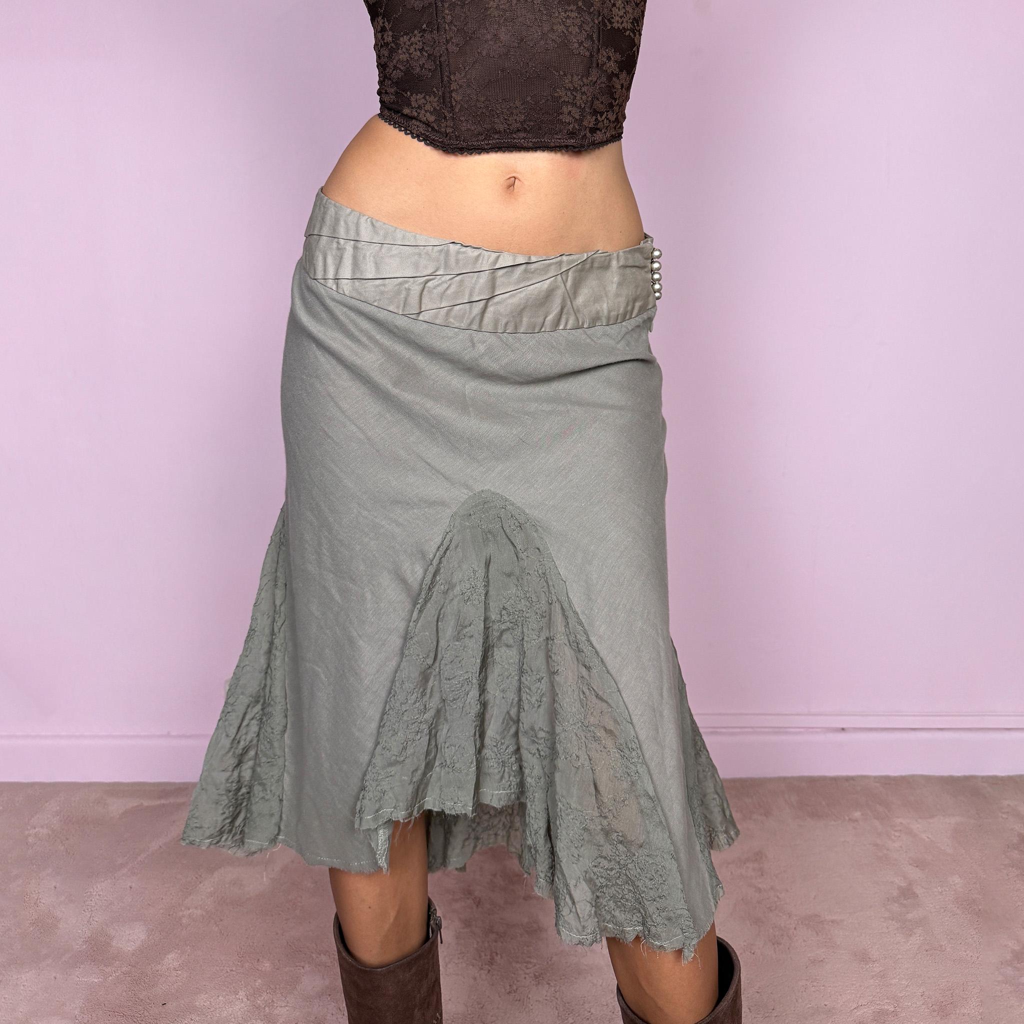 Vintage 2000s khaki green midi skirt, made in Italy and crafted from a lightweight 60% cotton and 40% silk blend. Features an asymmetric hem, delicate semi-sheer godet-style inserts, raw-edged detailing, and round bead-like buttons for an ethereal, fairy-like deconstructed feel. Finished with a side zip closure and no stretch. Can be worn mid- to low-rise for sizes XS–S. From an Italian brand. Excellent vintage condition.