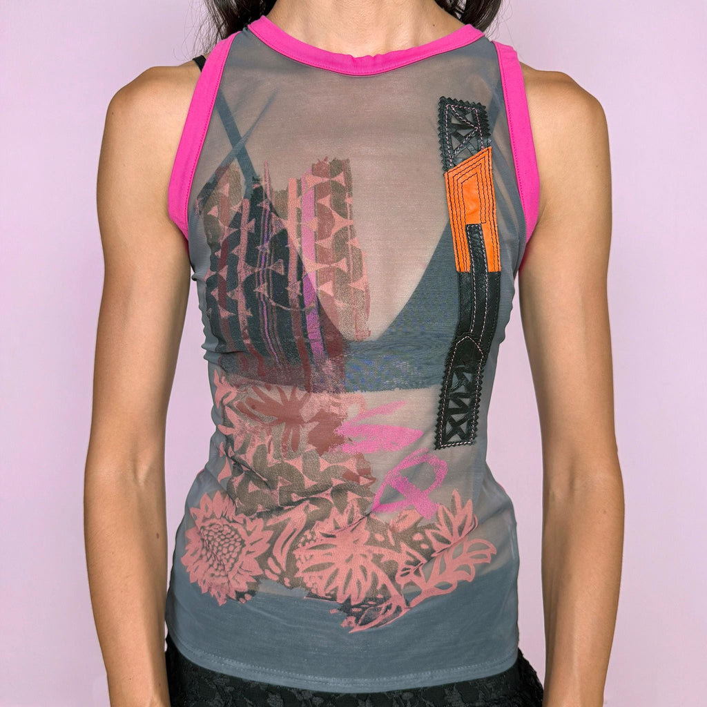 Vintage 2000s Save the Queen sleeveless sheer mesh top featuring an eclectic mixed graphic print in gray with vivid fuchsia contrast trim, intricate embroidery, and genuine leather appliqué inserts across the front, plus textured geometric detailing throughout the back. Perfect for bold, deconstructed summer outfits. Made in Italy from 100% polyamide with leather inserts. Excellent vintage condition.