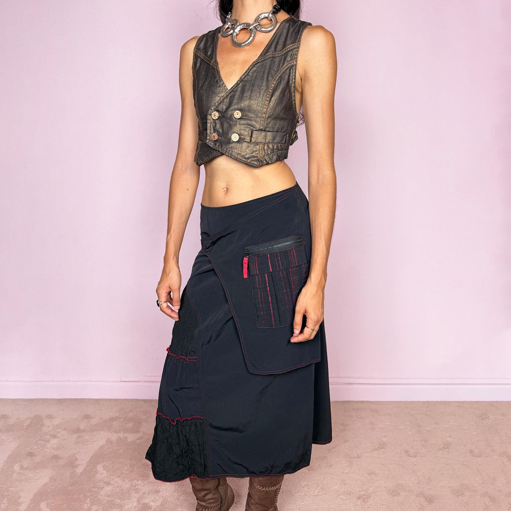 Vintage 2000s black deconstructed midi skirt with a structured, non-stretch feel. Features asymmetric paneled construction, contrasting red topstitching, a utility-inspired zip pocket, and layered crinkled fabric inserts. Finished with a back zip closure. A distinctive dark avant-garde piece with a dystopian, futuristic Y2K feel. Can be worn high-waisted for size M or mid- to lower-rise for sizes S–XS. Made in France by a French brand.