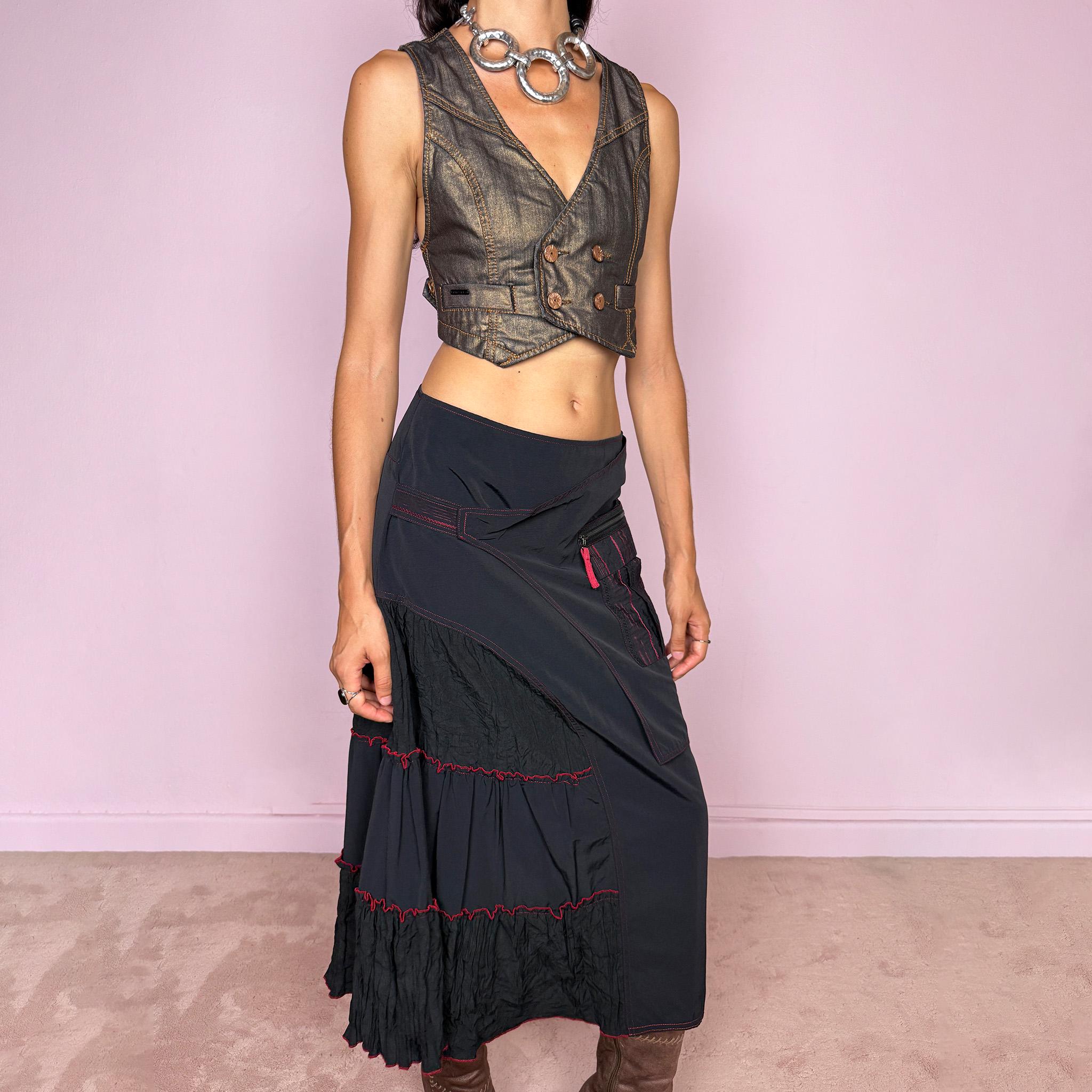 Vintage 2000s black deconstructed midi skirt with a structured, non-stretch feel. Features asymmetric paneled construction, contrasting red topstitching, a utility-inspired zip pocket, and layered crinkled fabric inserts. Finished with a back zip closure. A distinctive dark avant-garde piece with a dystopian, futuristic Y2K feel. Can be worn high-waisted for size M or mid- to lower-rise for sizes S–XS. Made in France by a French brand.