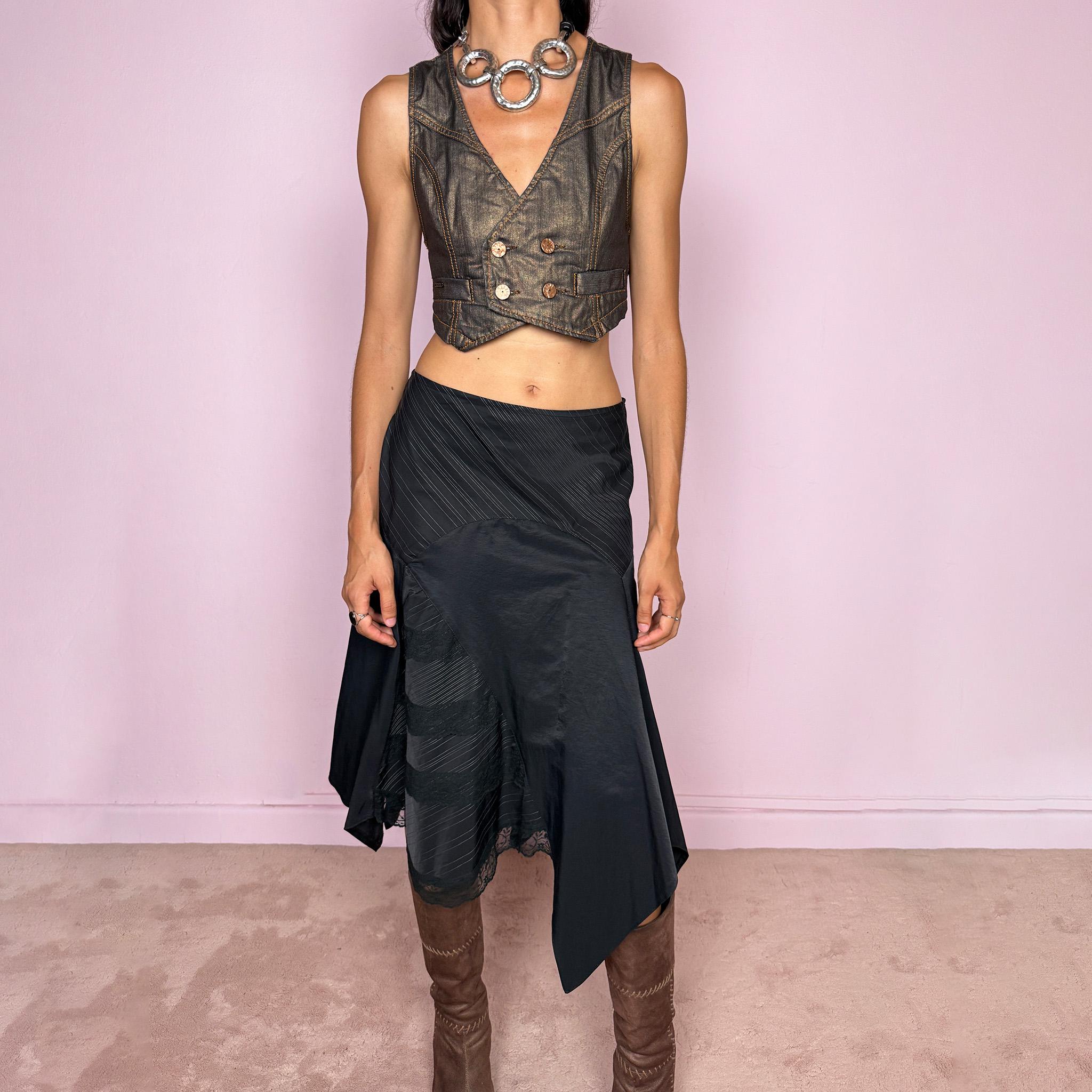 Vintage 2000s black asymmetric midi skirt featuring a deconstructed patchwork construction that combines fine pinstripe panels with contrasting fabric sections and subtle lace-trim detailing. Designed with a dramatic irregular handkerchief-style hem and a dark avant-garde Y2K silhouette. Features a side zip closure and no stretch. Can be worn high-waisted for size M or mid- to lower-rise for sizes S–XS.