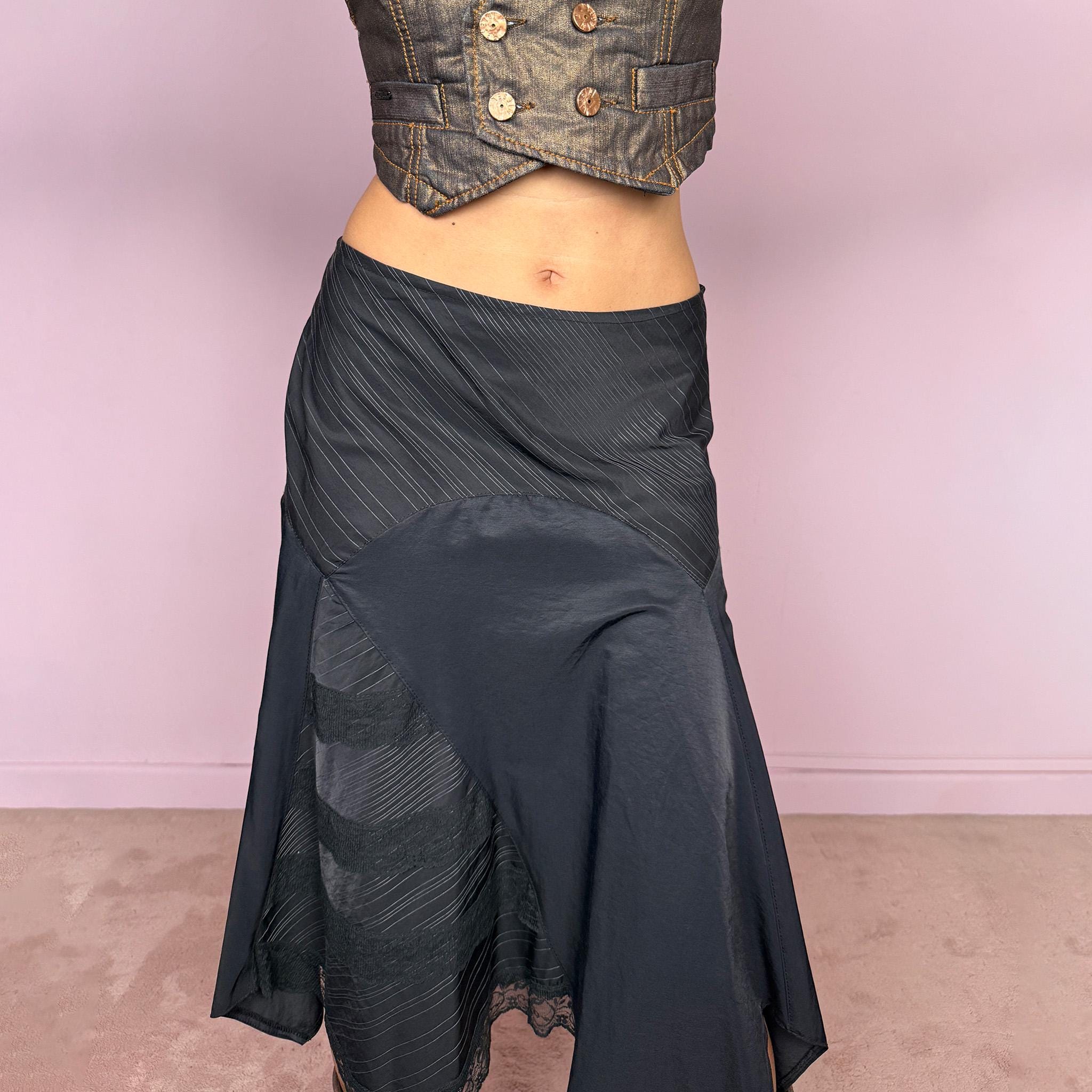 Vintage 2000s black asymmetric midi skirt featuring a deconstructed patchwork construction that combines fine pinstripe panels with contrasting fabric sections and subtle lace-trim detailing. Designed with a dramatic irregular handkerchief-style hem and a dark avant-garde Y2K silhouette. Features a side zip closure and no stretch. Can be worn high-waisted for size M or mid- to lower-rise for sizes S–XS.