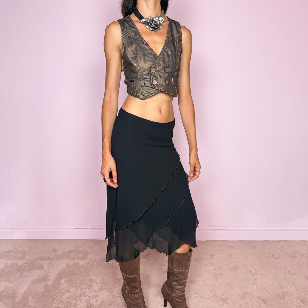 Vintage 2000s black asymmetric midi skirt crafted from 100% silk, featuring a layered construction with overlapping diagonal panels and delicate lettuce-edge finishing throughout. Features a side zip closure and no stretch. An elegant, dark minimalist avant-garde silhouette with beautiful fluid movement. Can be worn mid-rise for size M or lower-rise for size S. By German fashion brand Marc Cain. 100% silk outer with 100% nylon lining. Excellent vintage condition.
