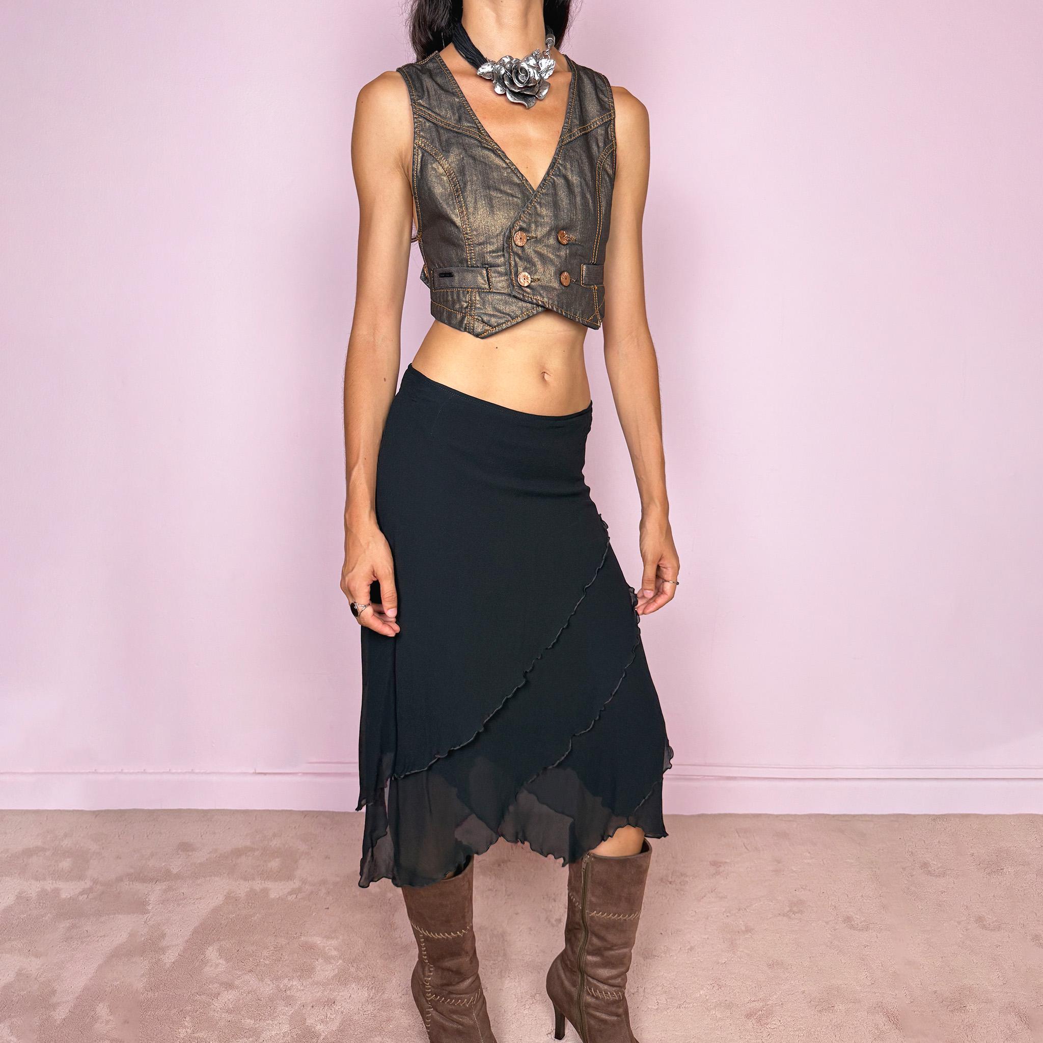 Vintage 2000s black asymmetric midi skirt crafted from 100% silk, featuring a layered construction with overlapping diagonal panels and delicate lettuce-edge finishing throughout. Features a side zip closure and no stretch. An elegant, dark minimalist avant-garde silhouette with beautiful fluid movement. Can be worn mid-rise for size M or lower-rise for size S. By German fashion brand Marc Cain. 100% silk outer with 100% nylon lining. Excellent vintage condition.