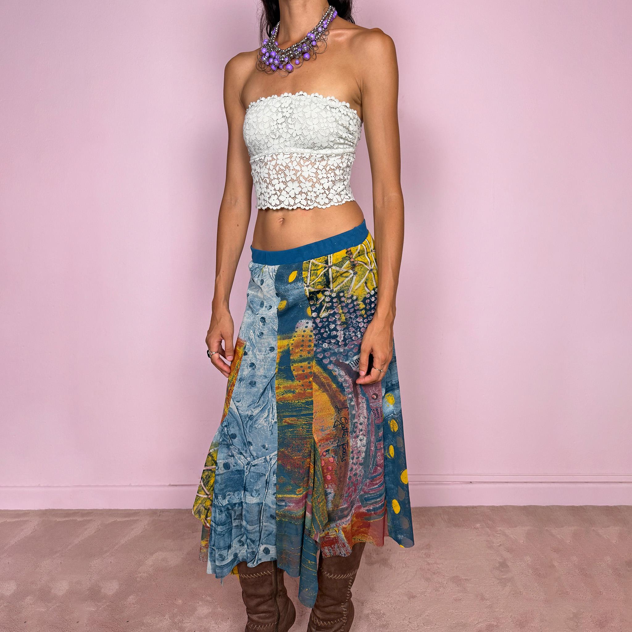 Vintage 2000s asymmetric mesh midi skirt crafted from lightweight, semi-sheer mesh with a fluid patchwork construction combining abstract graphic prints, painterly textures, and contrasting color panels in washed blue, yellow, orange, and earthy tones. Finished with an irregular handkerchief-style hem and layered inserts for a deconstructed, maximalist wearable-art Y2K silhouette.