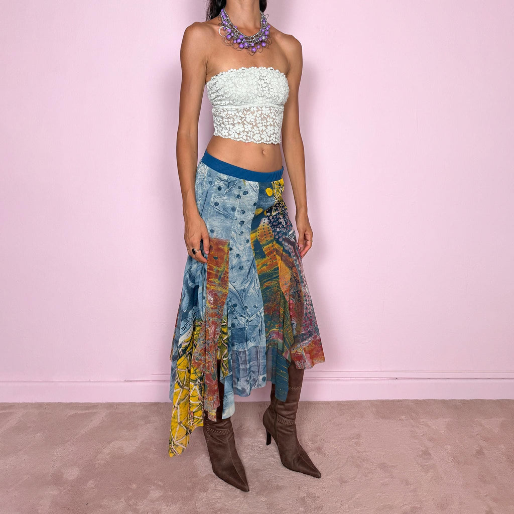 Vintage 2000s asymmetric mesh midi skirt crafted from lightweight, semi-sheer mesh with a fluid patchwork construction combining abstract graphic prints, painterly textures, and contrasting color panels in washed blue, yellow, orange, and earthy tones. Finished with an irregular handkerchief-style hem and layered inserts for a deconstructed, maximalist wearable-art Y2K silhouette.