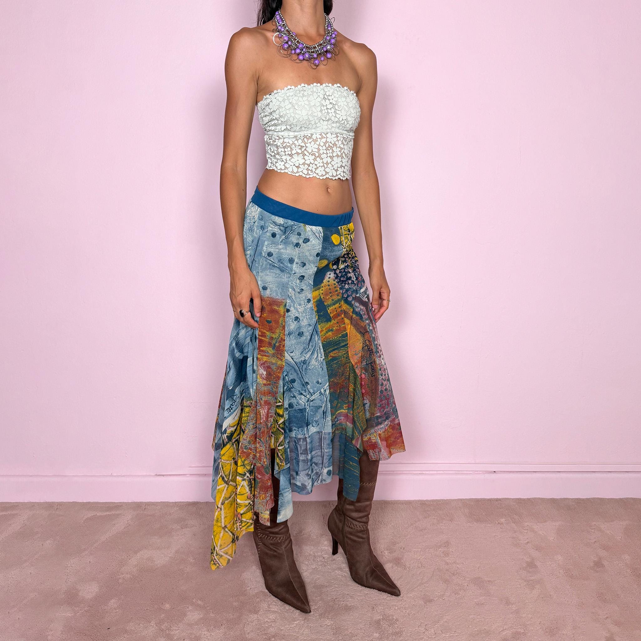 Vintage 2000s asymmetric mesh midi skirt crafted from lightweight, semi-sheer mesh with a fluid patchwork construction combining abstract graphic prints, painterly textures, and contrasting color panels in washed blue, yellow, orange, and earthy tones. Finished with an irregular handkerchief-style hem and layered inserts for a deconstructed, maximalist wearable-art Y2K silhouette.
