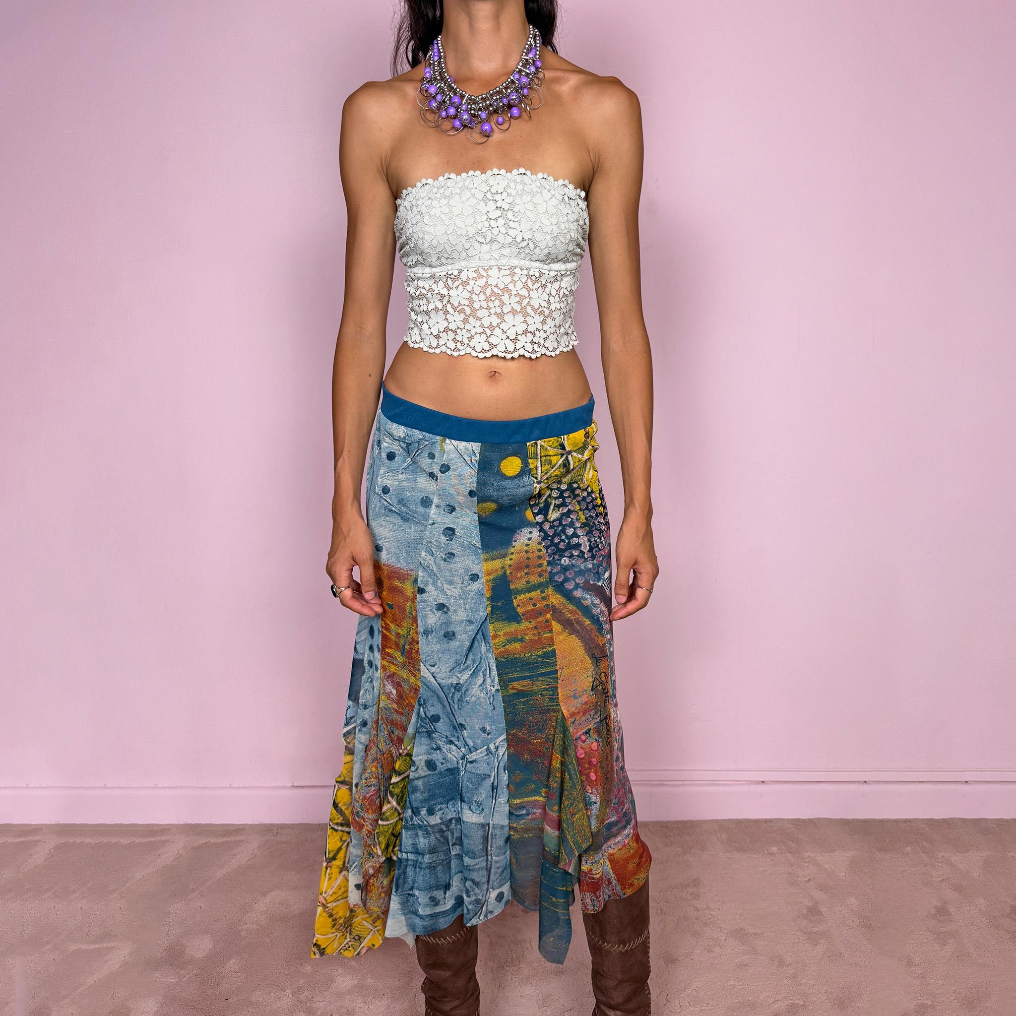 Vintage 2000s asymmetric mesh midi skirt crafted from lightweight, semi-sheer mesh with a fluid patchwork construction combining abstract graphic prints, painterly textures, and contrasting color panels in washed blue, yellow, orange, and earthy tones. Finished with an irregular handkerchief-style hem and layered inserts for a deconstructed, maximalist wearable-art Y2K silhouette.