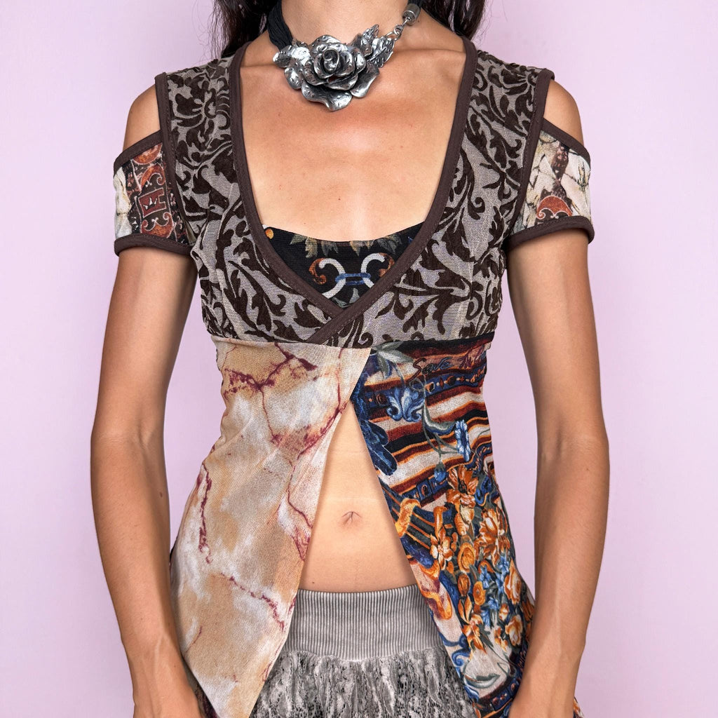 Vintage 2000s Save the Queen deconstructed top featuring an eclectic patchwork construction with contrasting medieval-inspired, ornamental, and abstract prints in earthy brown, beige, burnt orange, and blue tones. Designed with a deep layered neckline, cut-out shoulders, and dramatic split-front panels that create an asymmetric, open silhouette through the waist. Stretchy with a fitted upper body and long irregular panels for a distinctly avant-garde Y2K look.