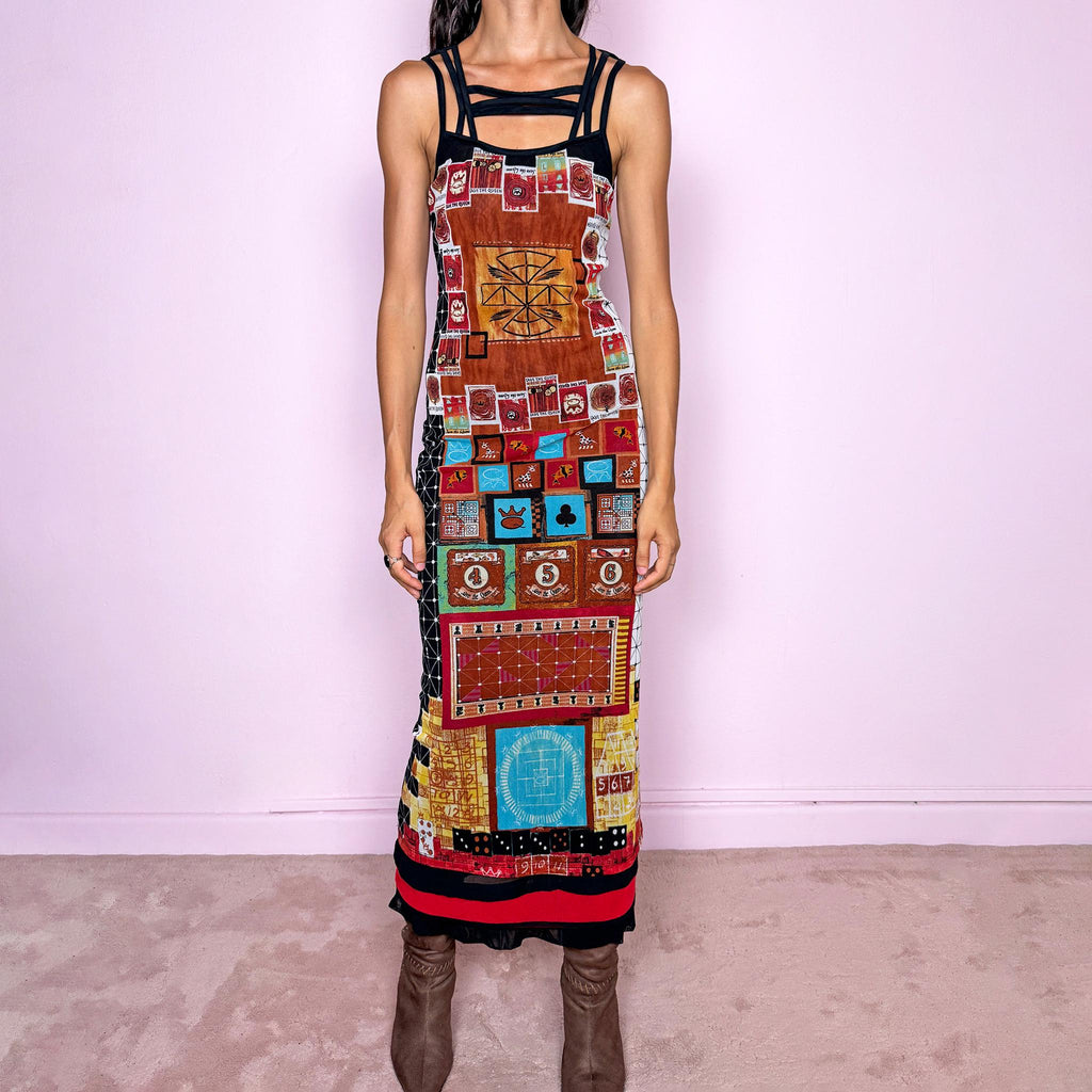Vintage 2000s Save the Queen maxi dress, made in Italy from stretchy 100% polyamide mesh with a black mesh lining. Featuring an intricate multicolored graphic print with abstract symbols, game-inspired motifs, and richly layered artwork throughout, framed by strappy black mesh detailing across the neckline and shoulders. The long, fitted silhouette and highly detailed print give it a distinctive maximalist, art-to-wear feel characteristic of Y2K Italian fashion.