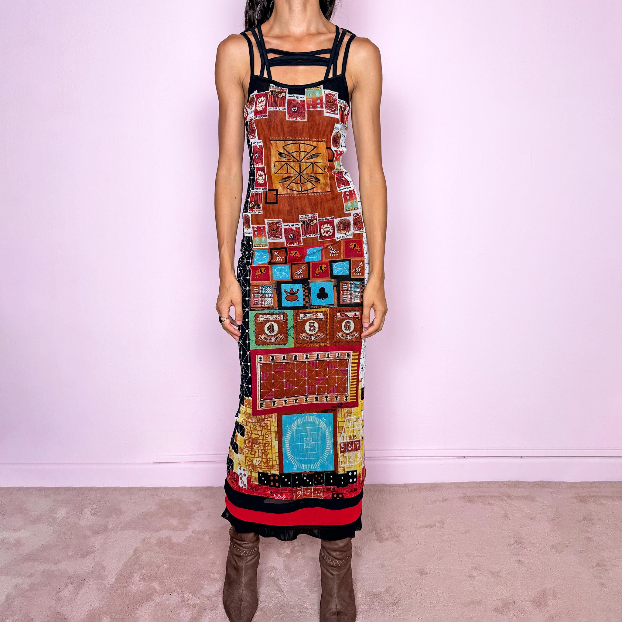 Vintage 2000s Save the Queen maxi dress, made in Italy from stretchy 100% polyamide mesh with a black mesh lining. Featuring an intricate multicolored graphic print with abstract symbols, game-inspired motifs, and richly layered artwork throughout, framed by strappy black mesh detailing across the neckline and shoulders. The long, fitted silhouette and highly detailed print give it a distinctive maximalist, art-to-wear feel characteristic of Y2K Italian fashion.