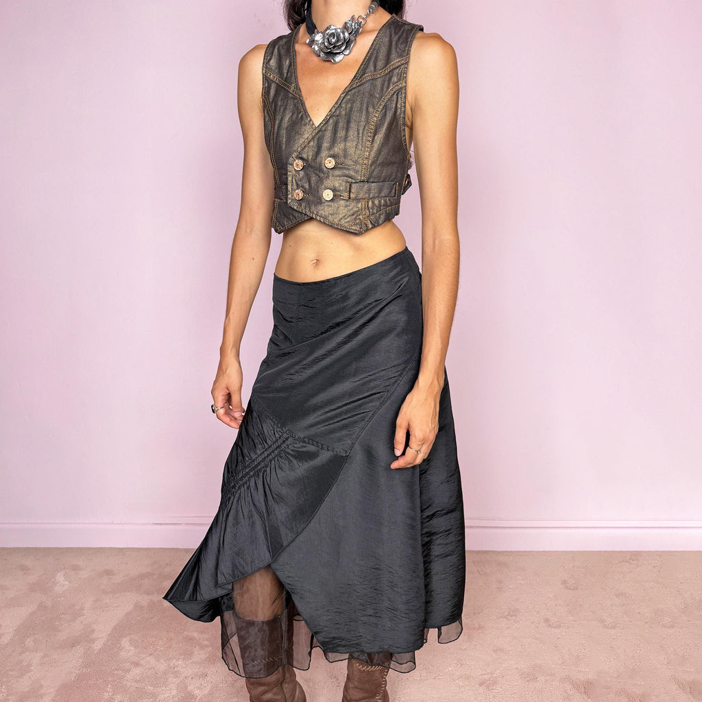 Vintage 2000s black midi skirt featuring an asymmetric deconstructed silhouette with diagonal paneling, gathered ruching, a sculptural draped insert, and a sheer black underlayer. Elegant dark avant-garde style, perfect for formal outfits. Non-stretch fabric with a back zip closure. Can be worn high-waisted for size M or slightly lower on the waist for sizes S and XS. Composition label is missing, so the exact fabric is unknown. From a French brand. Excellent vintage condition.