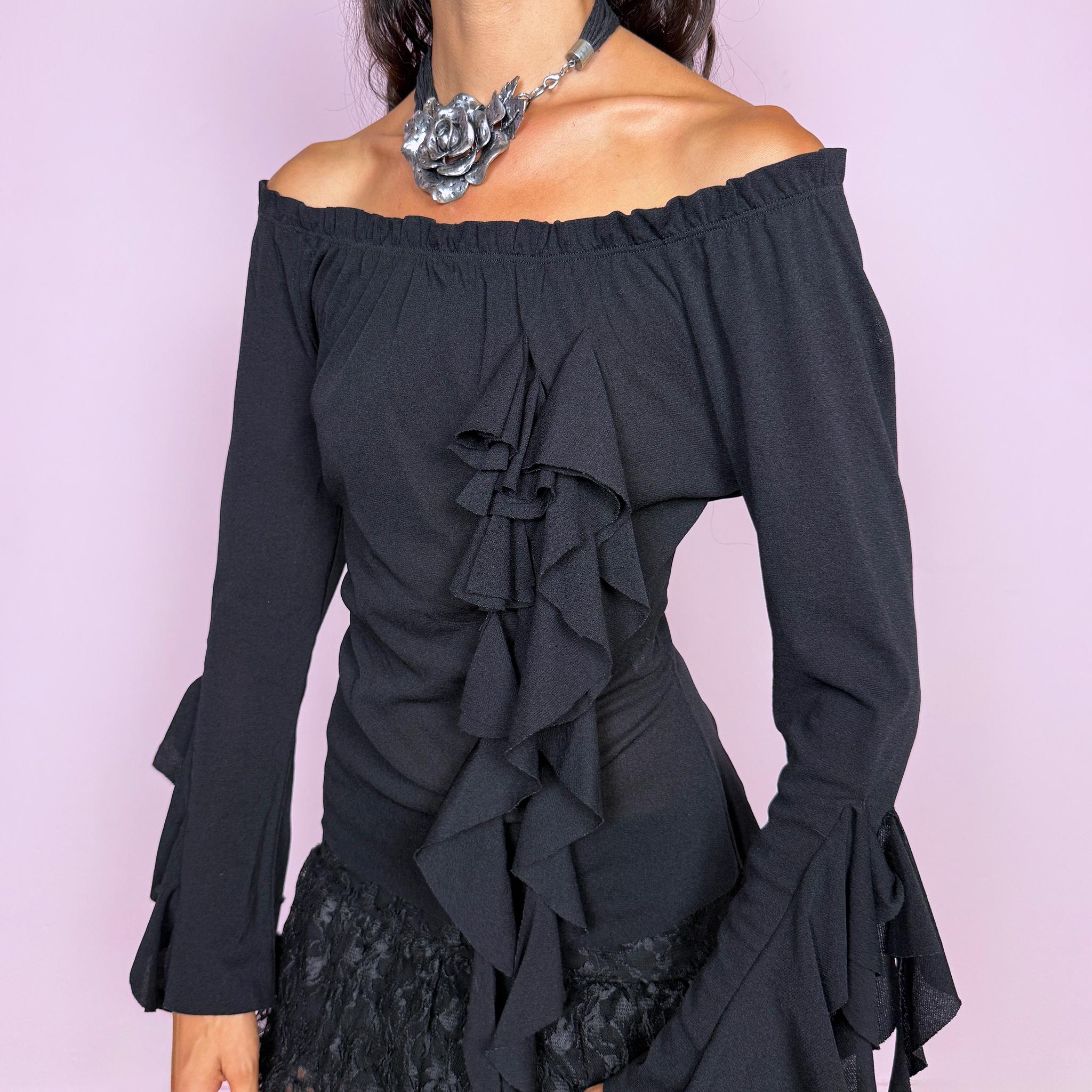 Vintage 2000s black top featuring an off-the-shoulder neckline, fitted silhouette, dramatic cascading front ruffles and flared ruffle cuffs, creating an asymmetric sculptural effect with an experimental avant-garde feel. Made in France by a French brand from stretchy 100% polyamide. Excellent vintage condition.