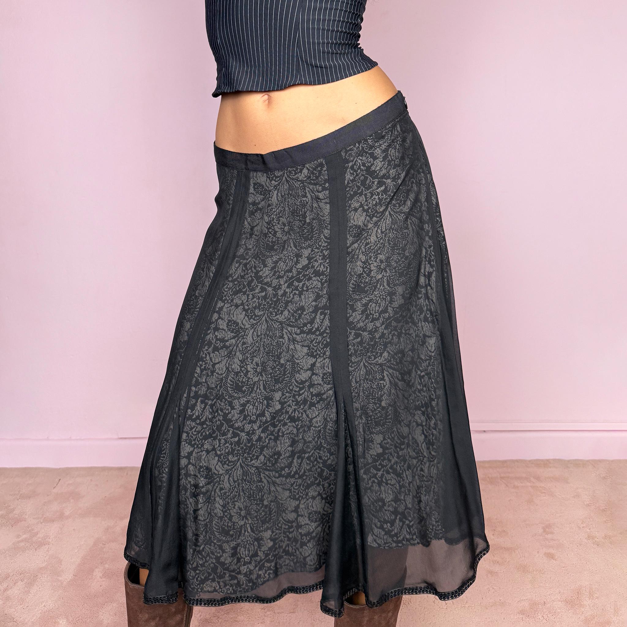 Vintage 2000s black silk A-line flared midi skirt crafted from 100% silk, with contrasting beige and black lining that subtly reveals an intricate dark floral paisley pattern through the outer fabric, a semi-sheer black overlay, and delicate black sequin trim along the edge. Elegant with a romantic eveningwear feel. Non-stretch with a side zip closure. Can be worn mid-rise for size M or lower-rise for size S. From a German brand. Excellent vintage condition.