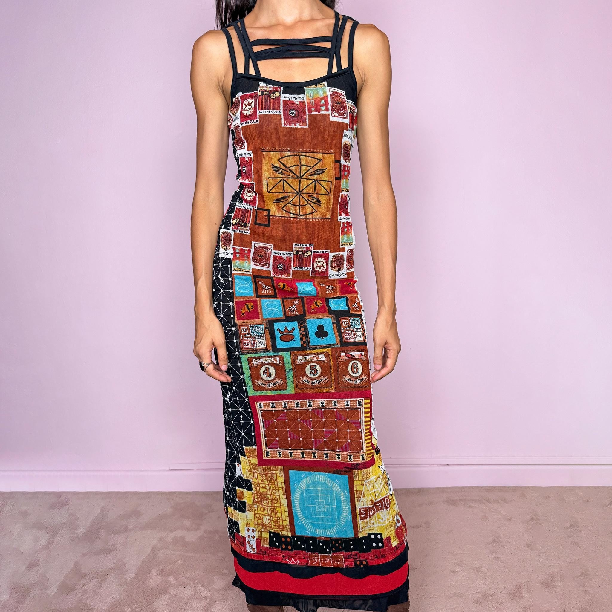 Vintage 2000s Save the Queen maxi dress, made in Italy from stretchy 100% polyamide mesh with a black mesh lining. Featuring an intricate multicolored graphic print with abstract symbols, game-inspired motifs, and richly layered artwork throughout, framed by strappy black mesh detailing across the neckline and shoulders. The long, fitted silhouette and highly detailed print give it a distinctive maximalist, art-to-wear feel characteristic of Y2K Italian fashion.