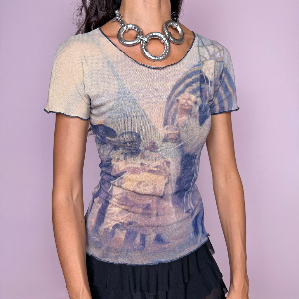 Vintage 2000s semi-sheer mesh top featuring an artistic photographic-style graphic print in muted beige and navy blue tones, with a fitted second-skin silhouette and short sleeves. The design has an art-to-wear feel with understated avant-garde appeal, perfect for bold, ethereal outfits. Designed by Finnish designer Ritva Falla for Marimekko and made in Finland from stretchy 100% polyamide. Excellent vintage condition.