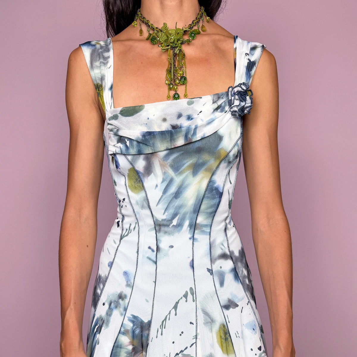 Vintage 2000s art-print midi dress featuring an abstract painterly graphic print in soft blue, gray, olive, and white tones, with a fitted bodice, square neckline, wide shoulder straps, and sculpted panel seams that open into a fluid flared skirt. Finished with a small rosette appliqué at the neckline. A distinctive Y2K art-to-wear piece. Made in the USA by an American brand from stretchy 100% polyamide mesh. Excellent vintage condition.