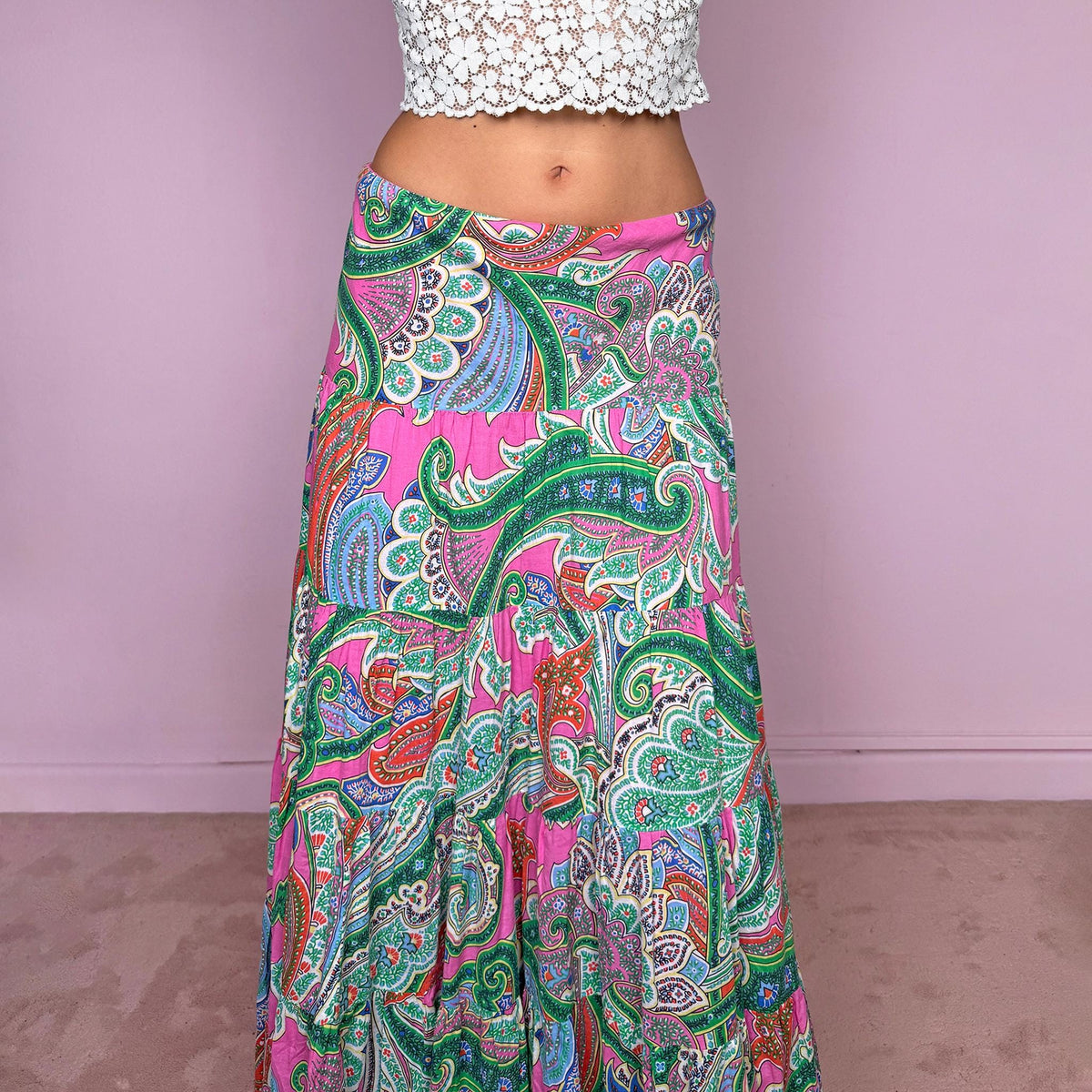 Vintage 2000s bohemian paisley maxi skirt, crafted from 100% cotton with a 100% cotton lining. Features a vibrant all-over paisley print in pink, green, blue, and orange tones, a softly flared tiered silhouette, and an elasticated waist. Can be worn mid- to low-rise for size S. By American brand Lauren Ralph Lauren. Excellent vintage condition.