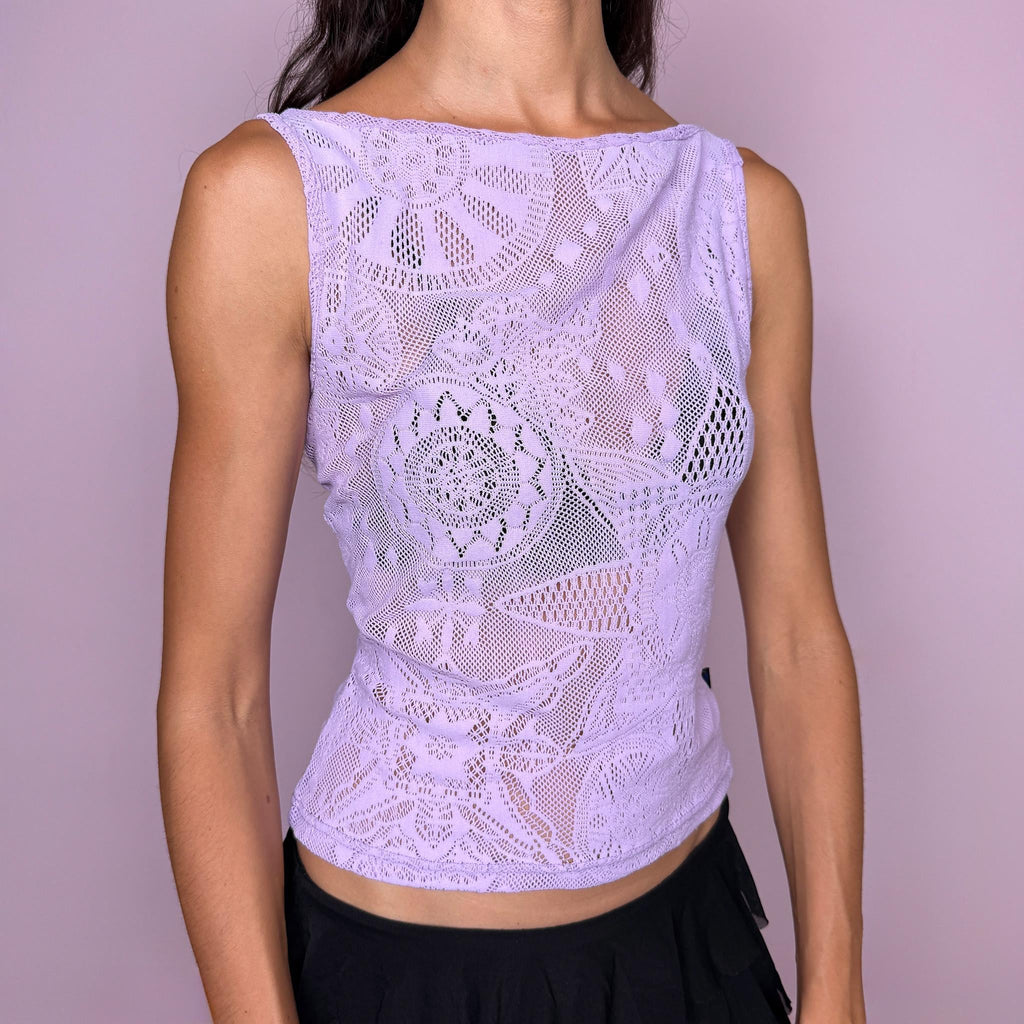 Vintage 2000s pastel lilac lace top by Christian Lacroix Jeans, made in Italy from a stretchy 95% polyamide and 5% elastane blend. Features an intricate semi-sheer floral lace construction, a sleeveless fitted silhouette, and a soft boat neckline. The dreamy pastel lilac tone and ornate lace pattern give it a romantic, ethereal Y2K designer feel. Excellent vintage condition.