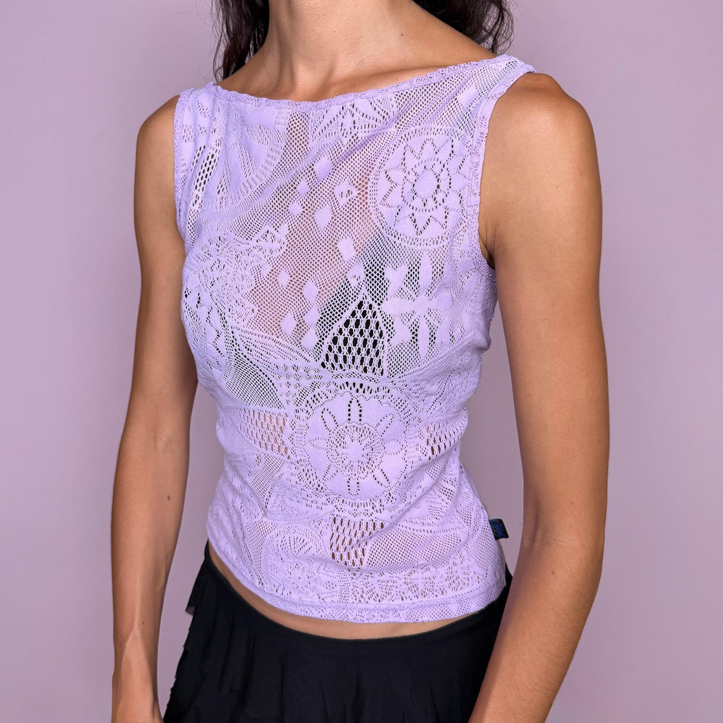 Vintage 2000s pastel lilac lace top by Christian Lacroix Jeans, made in Italy from a stretchy 95% polyamide and 5% elastane blend. Features an intricate semi-sheer floral lace construction, a sleeveless fitted silhouette, and a soft boat neckline. The dreamy pastel lilac tone and ornate lace pattern give it a romantic, ethereal Y2K designer feel. Excellent vintage condition.