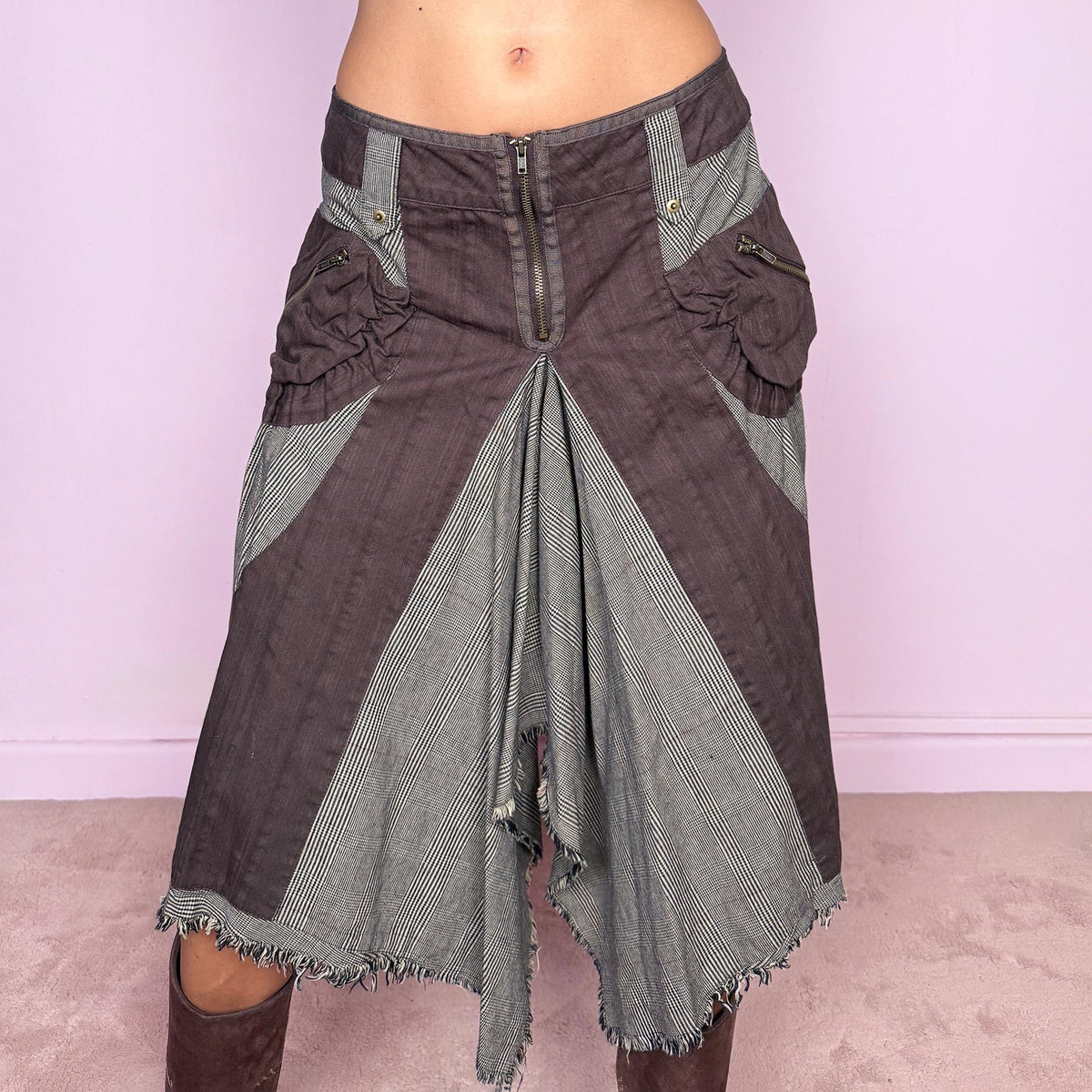 Vintage 2000s deconstructed midi skirt featuring an exposed front zip closure, contrast plaid panel inserts, utility-style pocket detailing, and dramatic asymmetric godet panels with raw frayed edges. The mix of brown and beige tones, visible construction details, and irregular hem give it a distinctly Y2K avant-garde, utilitarian aesthetic. Non-stretch. Can be worn mid-rise for size M or lower on the waist for size S. From a Dutch brand, made from 100% cotton. Excellent vintage condition.