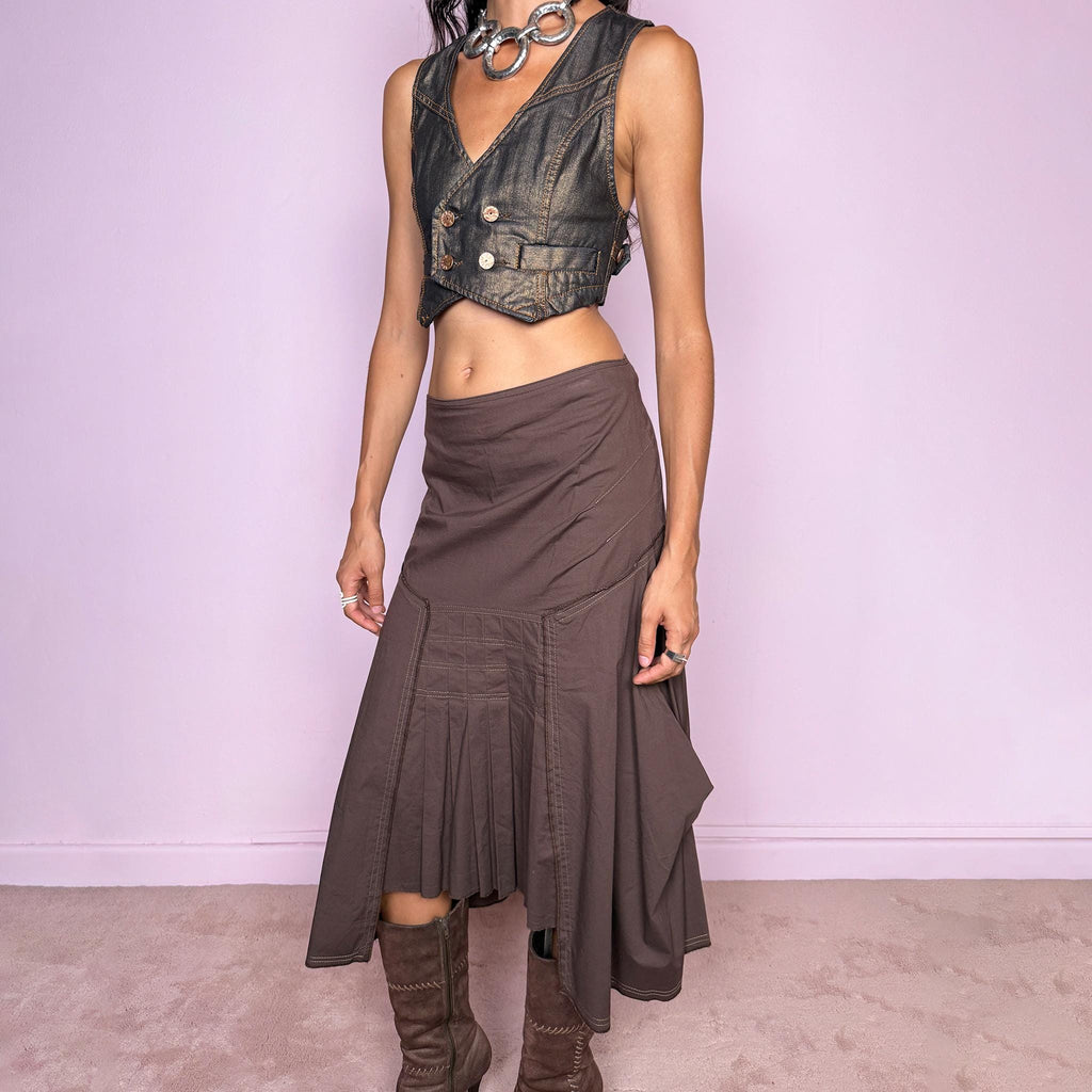 Vintage 2000s brown asymmetric midi skirt featuring a draped construction, contrast topstitching, and a sculptural asymmetric hem with pleated panel detailing at the front. Finished with a back zip closure. The earthy brown tone and deconstructed tailoring give it a distinctly avant-garde aesthetic. Can be worn mid-rise for size S or lower on the waist for size XS. From a French brand, made in France from a slightly stretchy 96% cotton and 4% elastane blend. Excellent vintage condition.