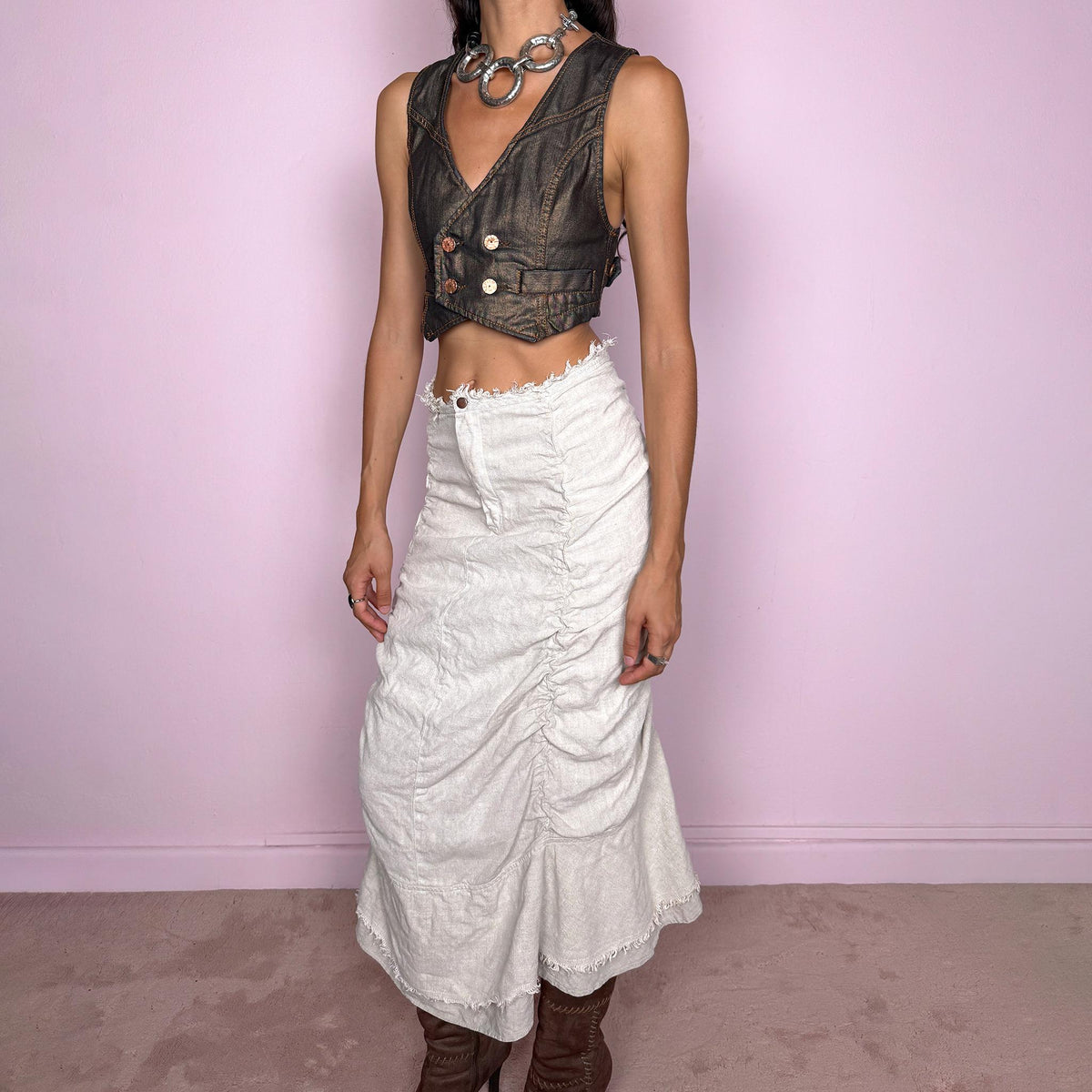 Vintage 2000s grayish off-white/light greige maxi skirt crafted from 100% linen, featuring sculptural ruched side detailing, softly gathered seams, and a flared layered hem with raw, frayed edges. The natural linen texture and muted earthy tone give it an avant-garde, rustic aesthetic. Non-stretch with a front zip closure. Can be worn high-waisted for size S or lower on the waist for size XS. Excellent vintage condition.