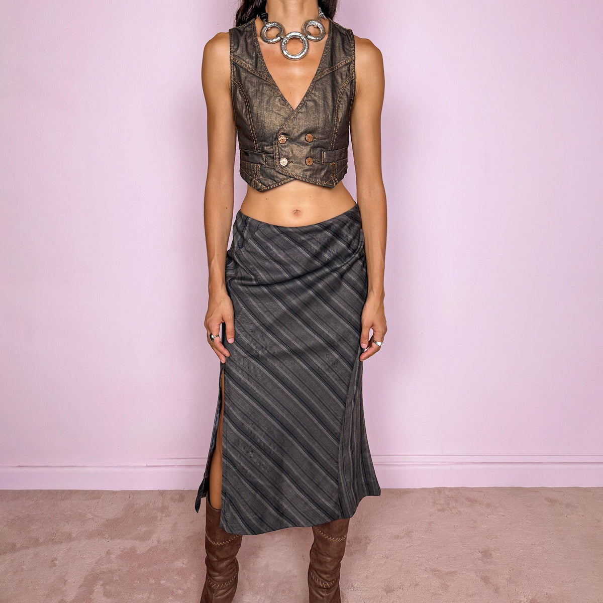 Vintage 2000s brownish-gray striped midi skirt by Kenzo Jungle, featuring diagonal stripe placement, a side slit, and a side zip closure. The muted brown-gray palette and refined tailoring give it a sophisticated, minimalist designer aesthetic. Can be worn mid-rise for size M. Crafted from a non-stretch blend of 58% viscose, 30% wool, 9% mohair, and 3% elastane, with a 100% polyester lining. Excellent vintage condition.