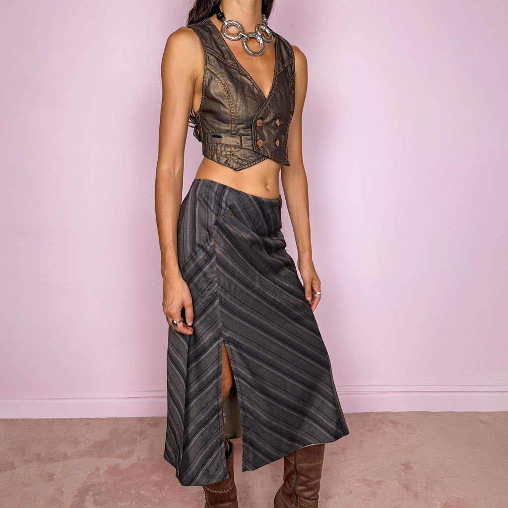 Vintage 2000s brownish-gray striped midi skirt by Kenzo Jungle, featuring diagonal stripe placement, a side slit, and a side zip closure. The muted brown-gray palette and refined tailoring give it a sophisticated, minimalist designer aesthetic. Can be worn mid-rise for size M. Crafted from a non-stretch blend of 58% viscose, 30% wool, 9% mohair, and 3% elastane, with a 100% polyester lining. Excellent vintage condition.