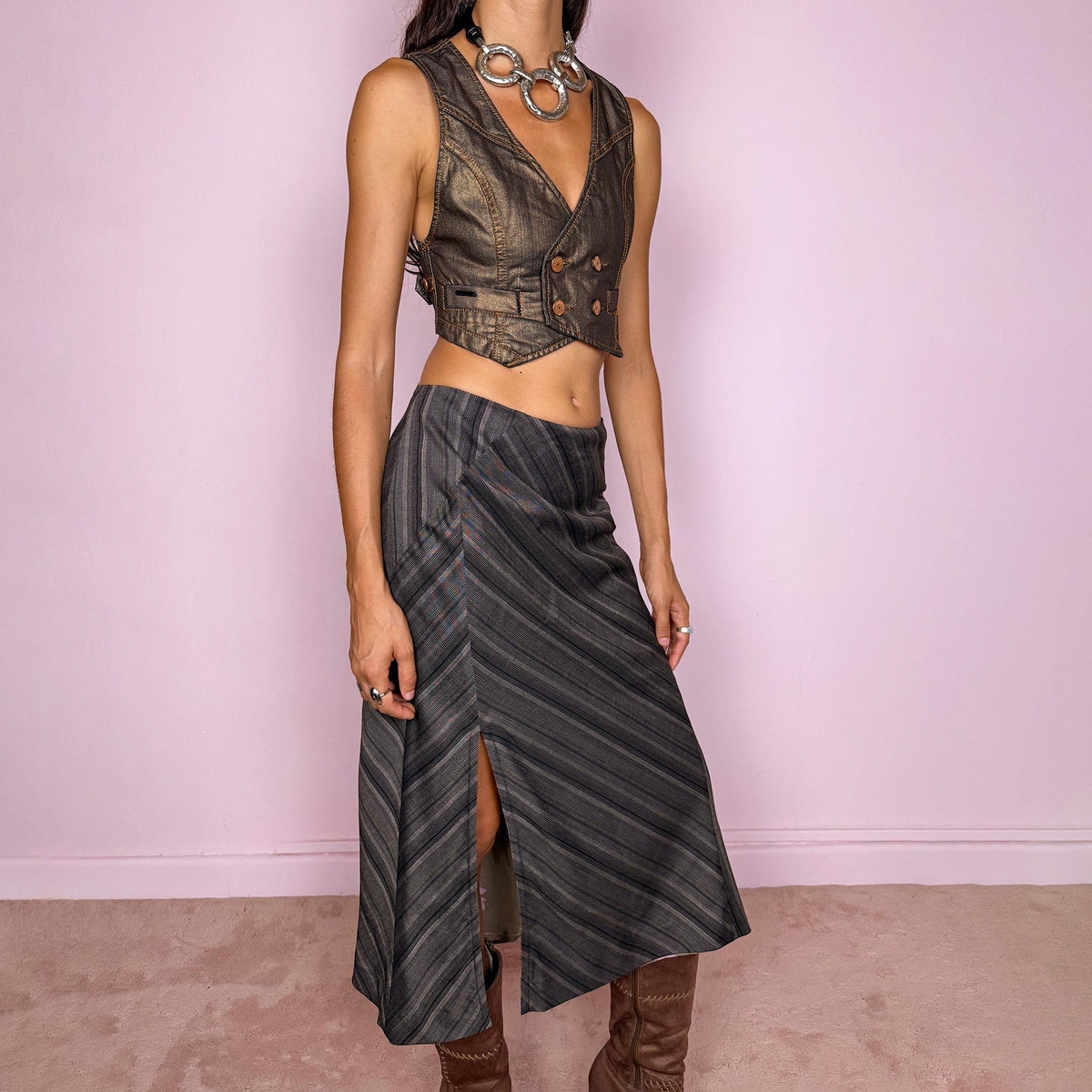 Vintage 2000s brownish-gray striped midi skirt by Kenzo Jungle, featuring diagonal stripe placement, a side slit, and a side zip closure. The muted brown-gray palette and refined tailoring give it a sophisticated, minimalist designer aesthetic. Can be worn mid-rise for size M. Crafted from a non-stretch blend of 58% viscose, 30% wool, 9% mohair, and 3% elastane, with a 100% polyester lining. Excellent vintage condition.