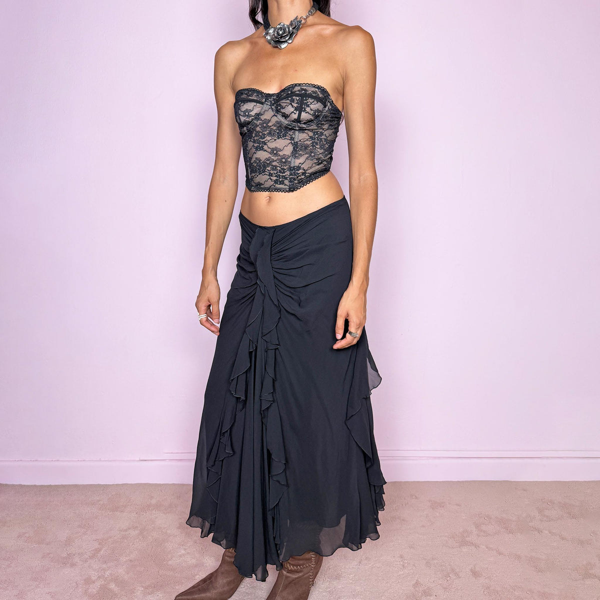 Vintage 2000s black silk midi skirt featuring soft ruching through the hips, cascading ruffle detailing down the front and sides, and a fluid flared hem for dramatic movement. Back zip closure and non-stretch. The layered silk construction and sculptural draping are ideal for elevated evening styling. Can be worn mid-rise for size M or lower on the waist for size S. Made in Italy by an Italian brand from 100% silk with a 100% polyester lining. Excellent vintage condition.