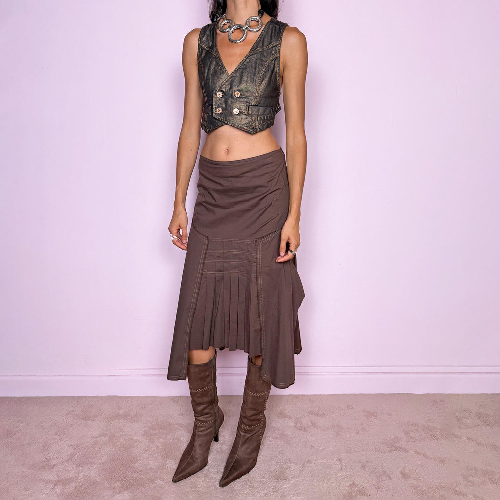 Vintage 2000s brown asymmetric midi skirt featuring a draped construction, contrast topstitching, and a sculptural asymmetric hem with pleated panel detailing at the front. Finished with a back zip closure. The earthy brown tone and deconstructed tailoring give it a distinctly avant-garde aesthetic. Can be worn mid-rise for size S or lower on the waist for size XS. From a French brand, made in France from a slightly stretchy 96% cotton and 4% elastane blend. Excellent vintage condition.