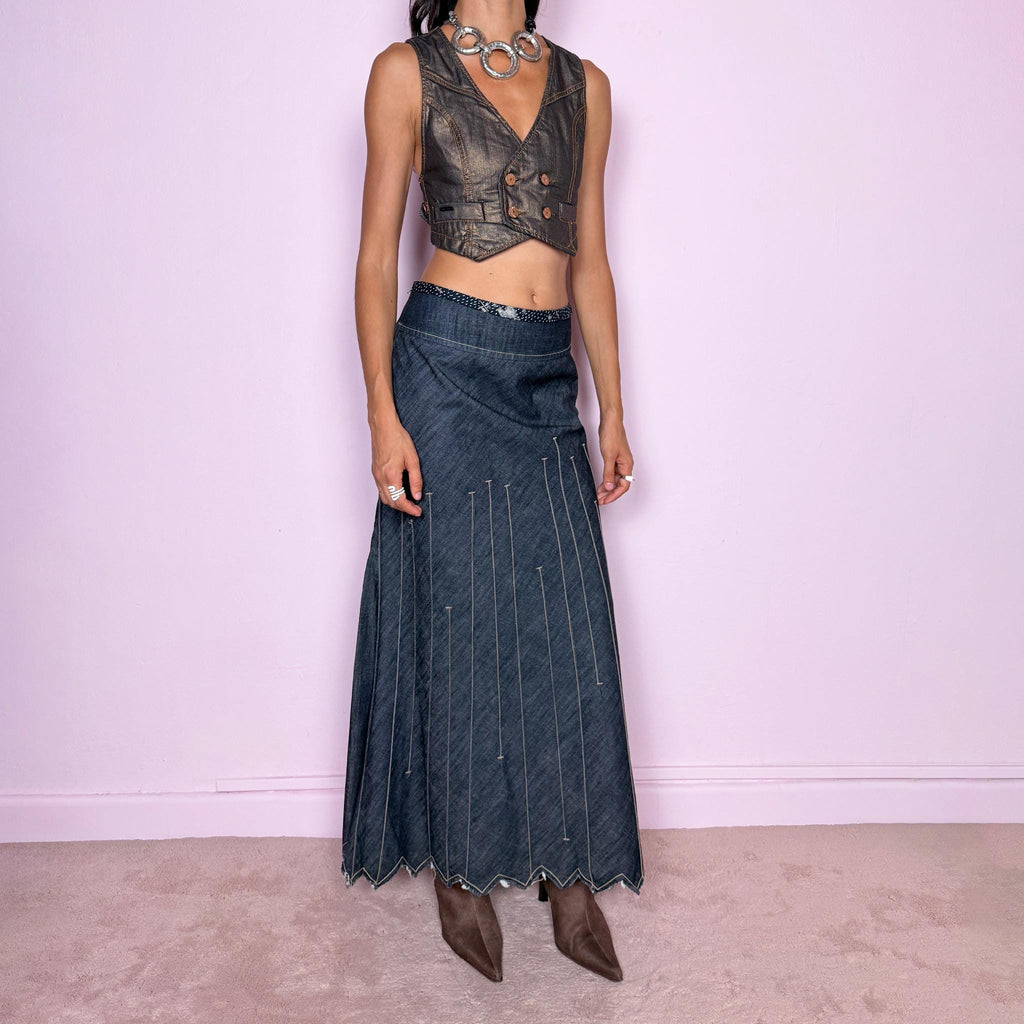 Vintage 2000s blue denim maxi skirt by Marithé + François Girbaud, from the Le Jean de Marithé + François Girbaud line. Made in Italy from a structured 77% cotton and 23% polyester blend. Featuring a side zip closure, contrast stitching, and a flared lower section with elongated vertical stitch detailing and a sculptural, pointed, frayed raw hem. Non-stretch. Can be worn mid-rise for size M. The architectural construction gives it an avant-garde designer aesthetic. Excellent vintage condition.