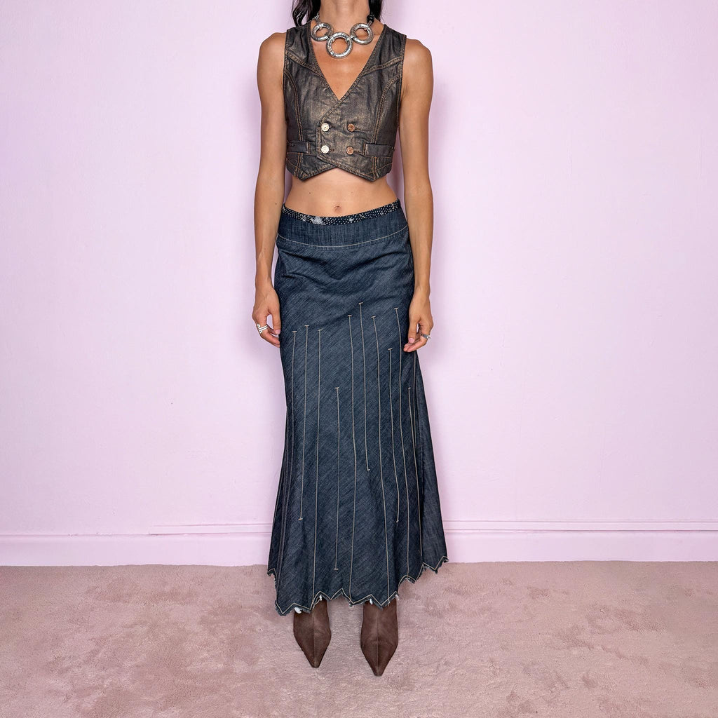 Vintage 2000s blue denim maxi skirt by Marithé + François Girbaud, from the Le Jean de Marithé + François Girbaud line. Made in Italy from a structured 77% cotton and 23% polyester blend. Featuring a side zip closure, contrast stitching, and a flared lower section with elongated vertical stitch detailing and a sculptural, pointed, frayed raw hem. Non-stretch. Can be worn mid-rise for size M. The architectural construction gives it an avant-garde designer aesthetic. Excellent vintage condition.