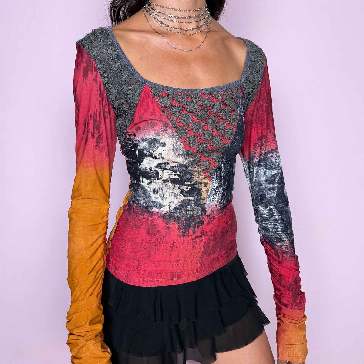 Vintage 2000s long-sleeve top by Italian label Save the Queen, featuring a fitted, body-skimming silhouette, scoop neckline, contrasting lace paneling across the upper bodice, and an abstract painterly print in red, orange, charcoal, and gray tones. Designed with extra-long ruched sleeves for a bold, maximalist aesthetic. Made in Italy from a stretchy 80% polyamide and 20% elastane blend. Excellent vintage condition.
