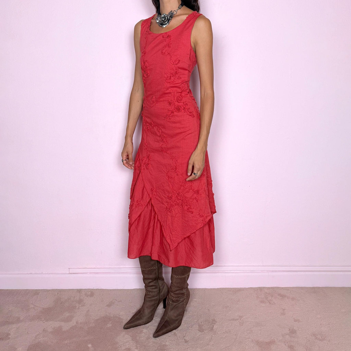 Vintage 2000s muted red midi dress featuring a fitted sleeveless bodice, subtle floral embroidery throughout, layered asymmetric paneling, and a softly flared tiered hem. Finished with a back zip closure. Non-stretch. The slightly faded brick-red tone, textured embroidery, and irregular layered construction give it a rustic, deconstructed aesthetic. Made in France from 100% cotton with a 100% polyester lining, from a French brand. Great vintage condition.