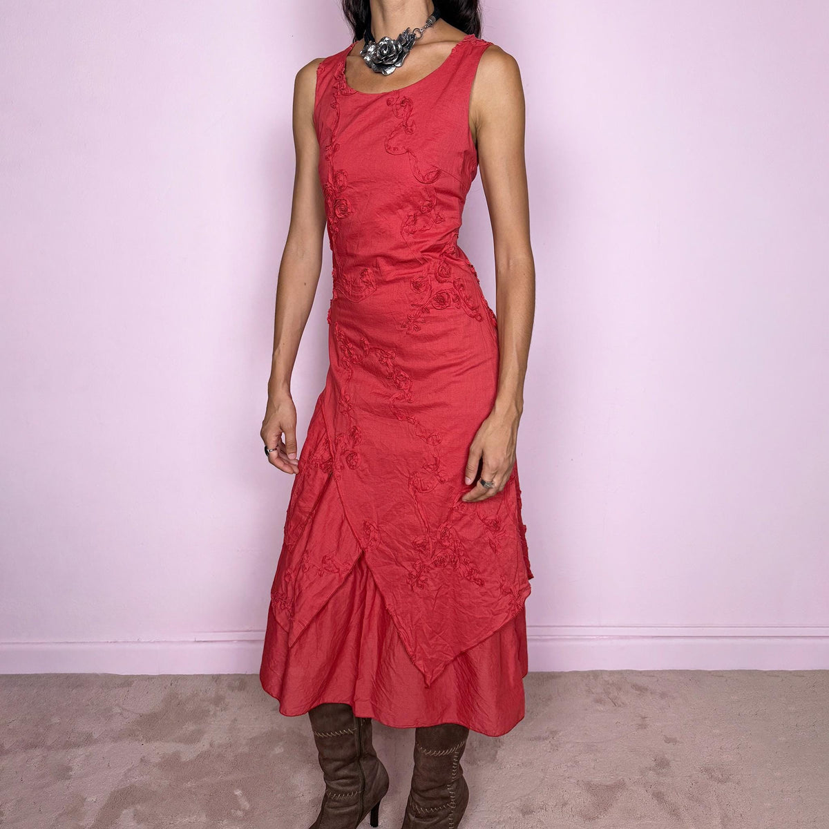 Vintage 2000s muted red midi dress featuring a fitted sleeveless bodice, subtle floral embroidery throughout, layered asymmetric paneling, and a softly flared tiered hem. Finished with a back zip closure. Non-stretch. The slightly faded brick-red tone, textured embroidery, and irregular layered construction give it a rustic, deconstructed aesthetic. Made in France from 100% cotton with a 100% polyester lining, from a French brand. Great vintage condition.