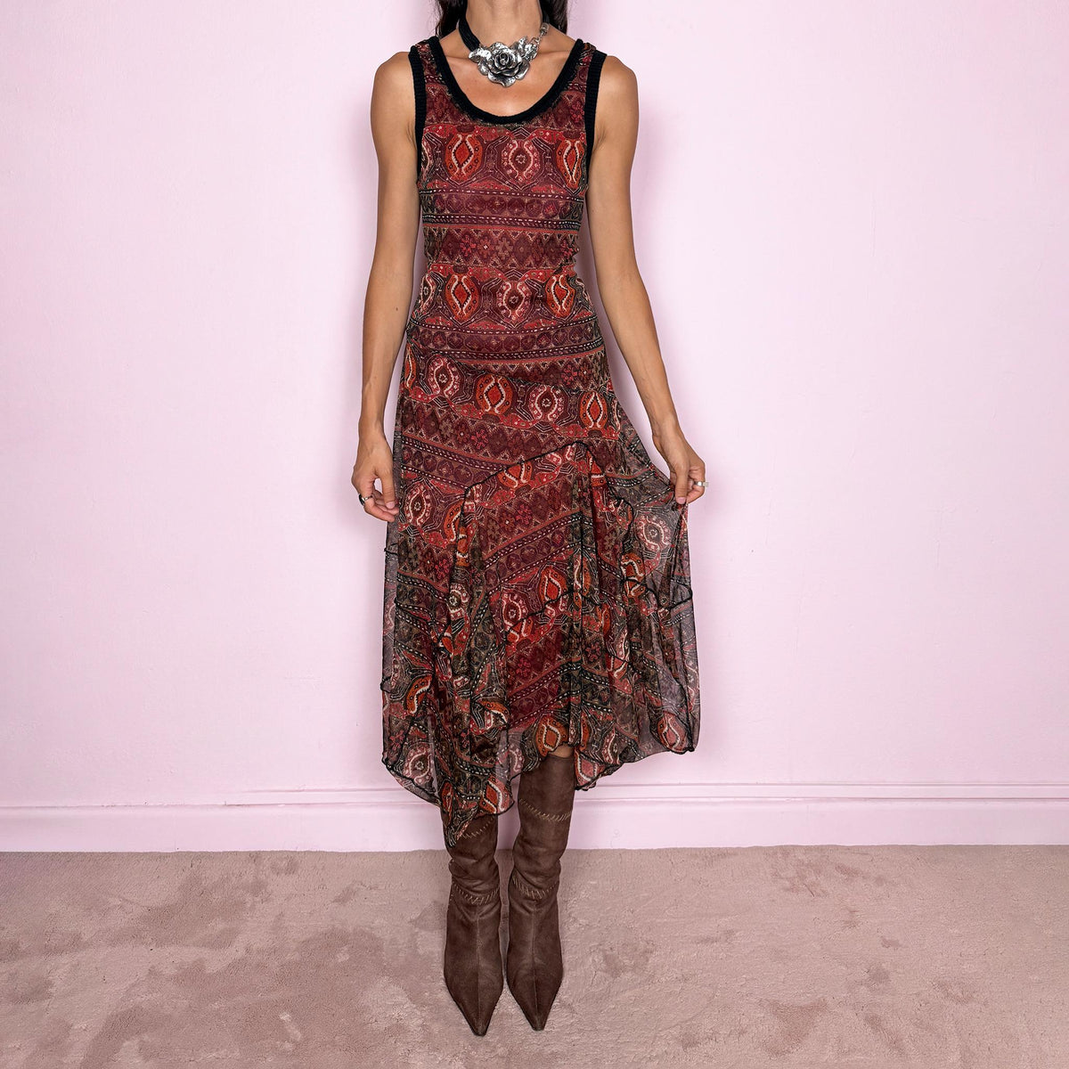 Vintage 2000s printed mesh two-piece dress set. The set includes a fitted sleeveless midi dress with a red lining and asymmetric layered hem, paired with a long-sleeve sheer mesh wrap top with tie fastening and contrasting black trim. Finished in an earthy red, burgundy, brown, and orange graphic print throughout. Perfect for layered bohemian styling. From a French brand, made in France from stretchy 100% polyester. Great vintage condition.