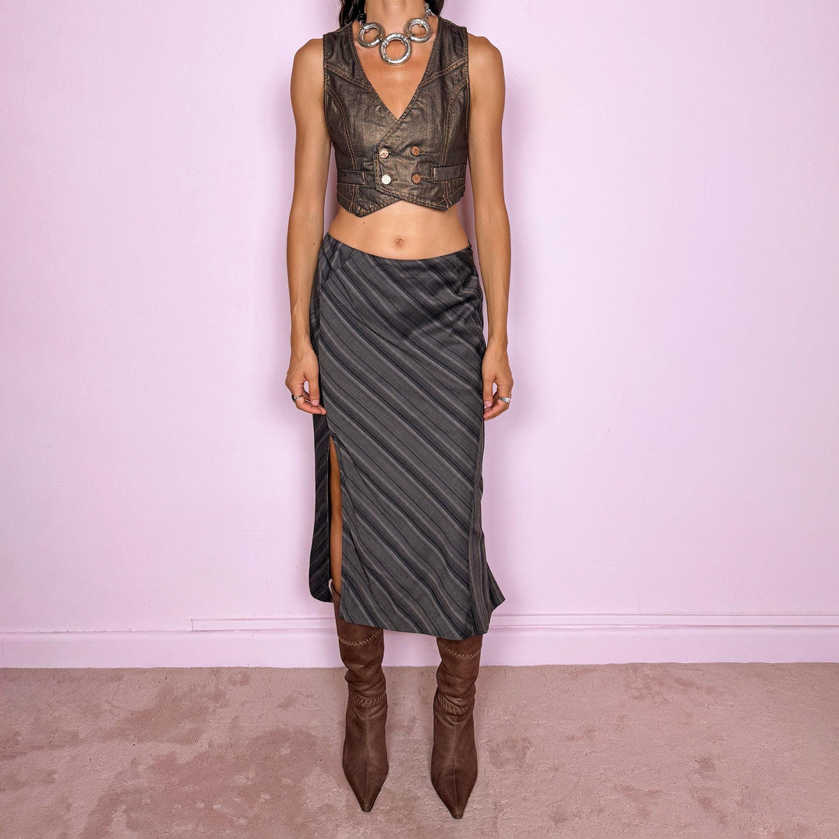 Vintage 2000s brownish-gray striped midi skirt by Kenzo Jungle, featuring diagonal stripe placement, a side slit, and a side zip closure. The muted brown-gray palette and refined tailoring give it a sophisticated, minimalist designer aesthetic. Can be worn mid-rise for size M. Crafted from a non-stretch blend of 58% viscose, 30% wool, 9% mohair, and 3% elastane, with a 100% polyester lining. Excellent vintage condition.